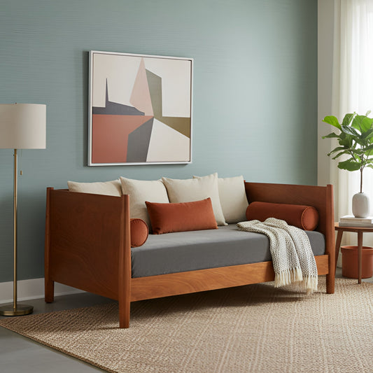 Flynn Day Bed in chestnut finish, styled with decorative pillows in a modern living room setting.