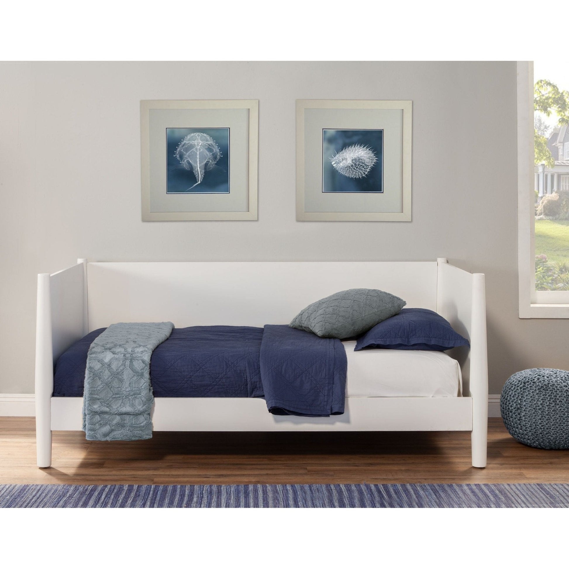 Flynn Day Bed in white with navy bedding, showcasing modern design and a cozy bedroom setup.
