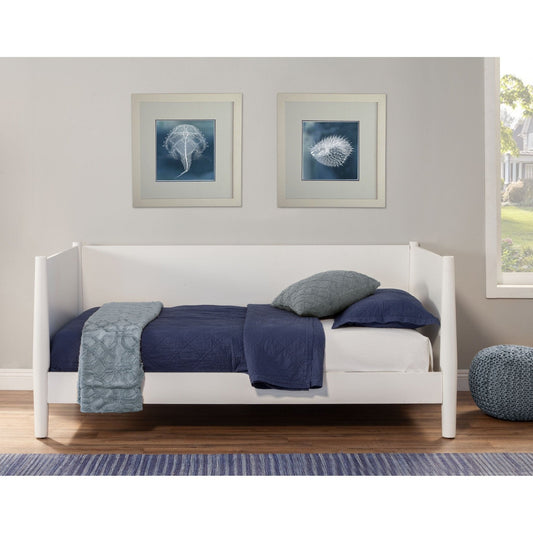 Flynn Day Bed in white with navy bedding, showcasing modern design and a cozy bedroom setup.