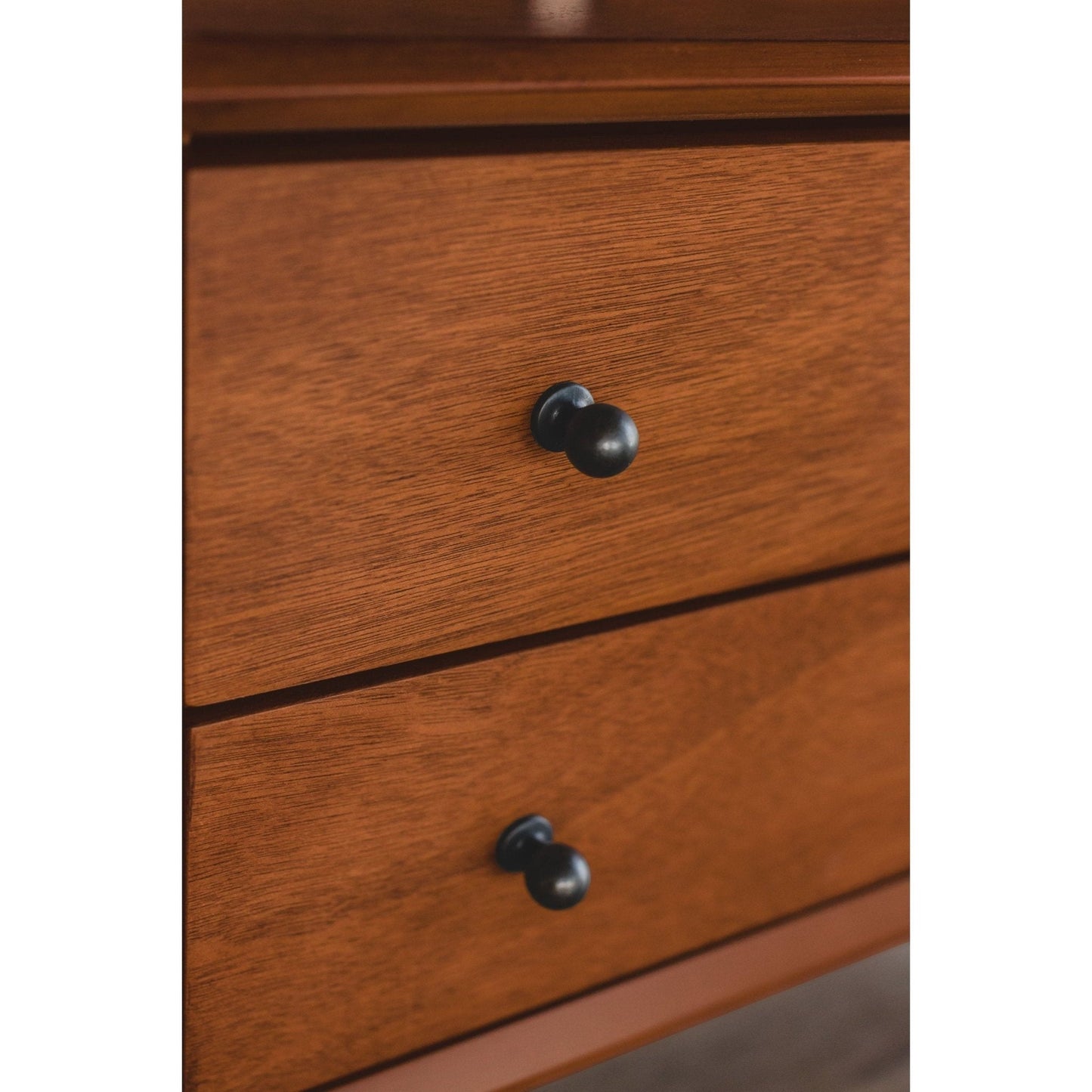 Close-up of Flynn Large Nightstand's chestnut drawers and black knobs, showcasing Mid-Century Modern design details.