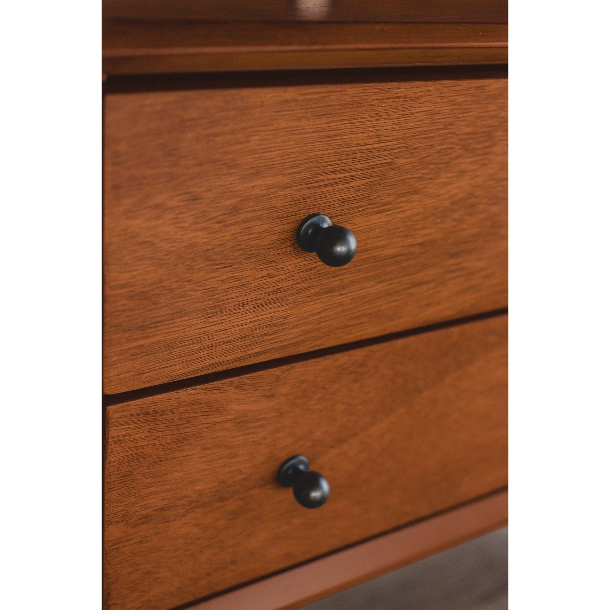 Close-up of Flynn Large Nightstand's chestnut drawers and black knobs, showcasing Mid-Century Modern design details.