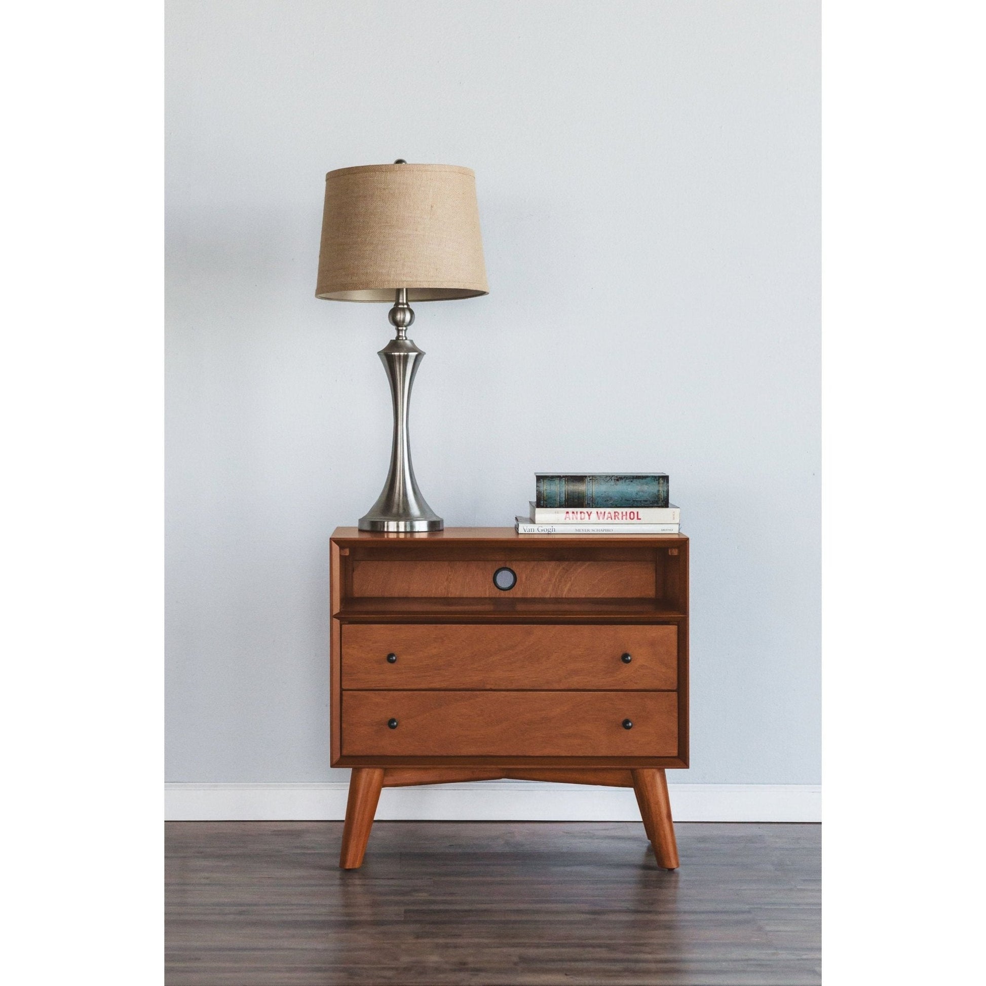 Flynn Large Nightstand in Chestnut finish with lamp and books, showcasing Mid-Century Modern design.