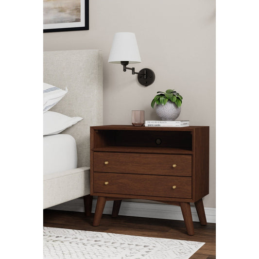 Flynn Large Nightstand in Walnut finish with two drawers beside a bed and stylish wall sconce.
