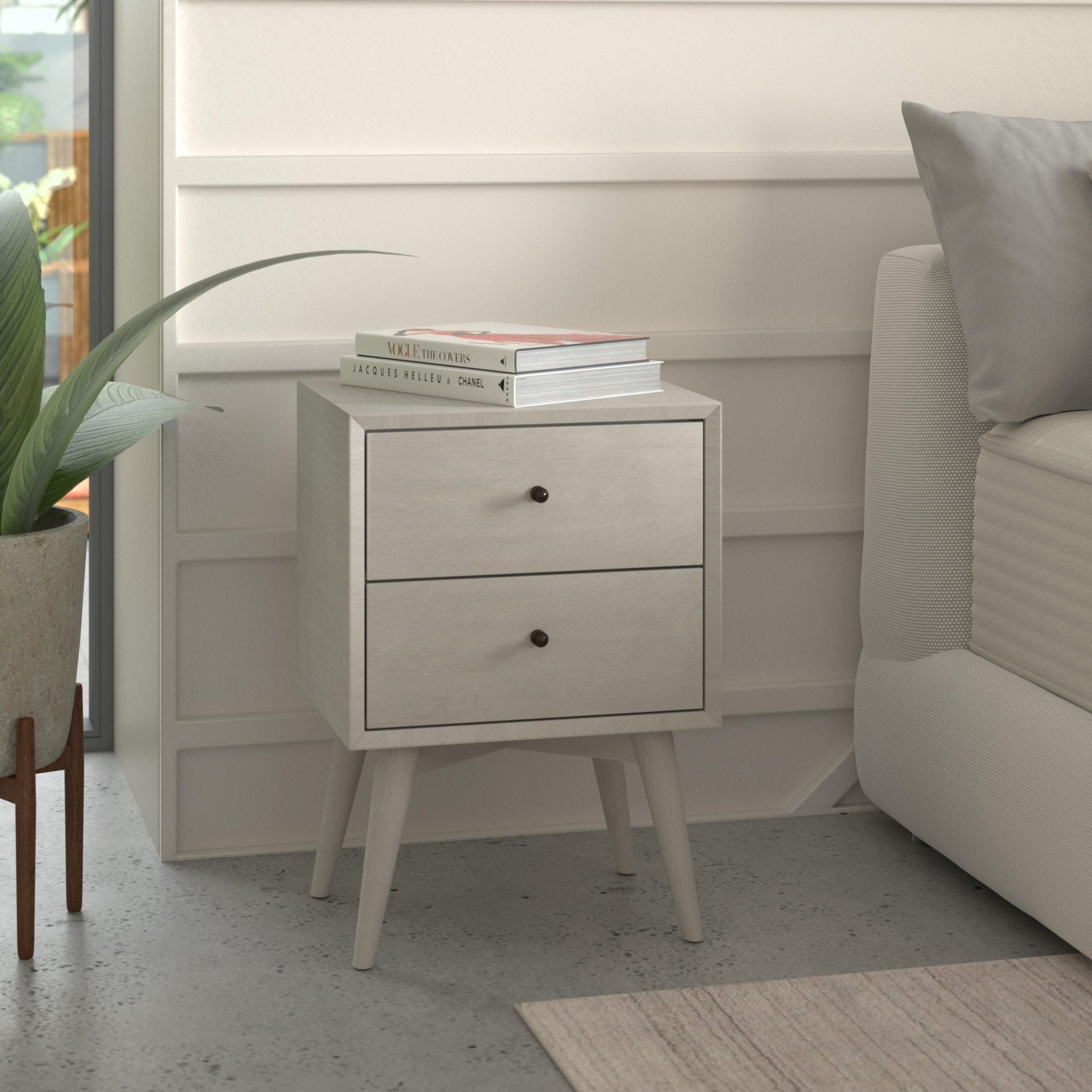 Flynn Nightstand in gray with two drawers beside a bed, featuring classic Mid-Century Modern design.