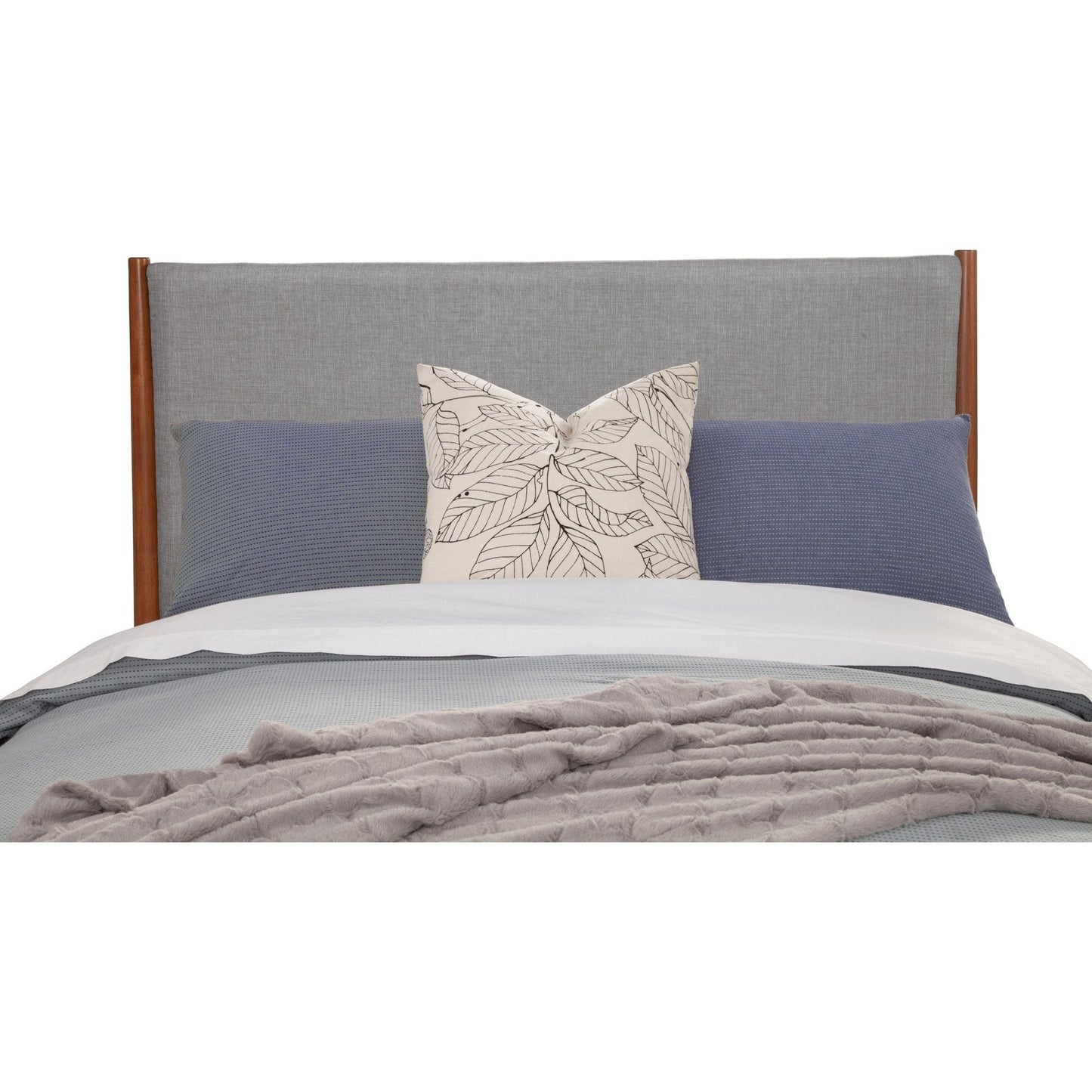 Flynn Panel Bed headboard featuring a chic design with decorative pillows in grey and blue.
