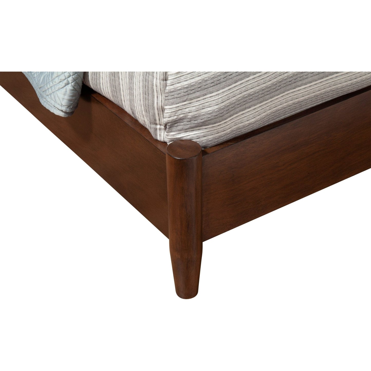 Close-up view of the Flynn Panel Bed, Walnut, showcasing its elegant leg design and solid Mahogany construction.