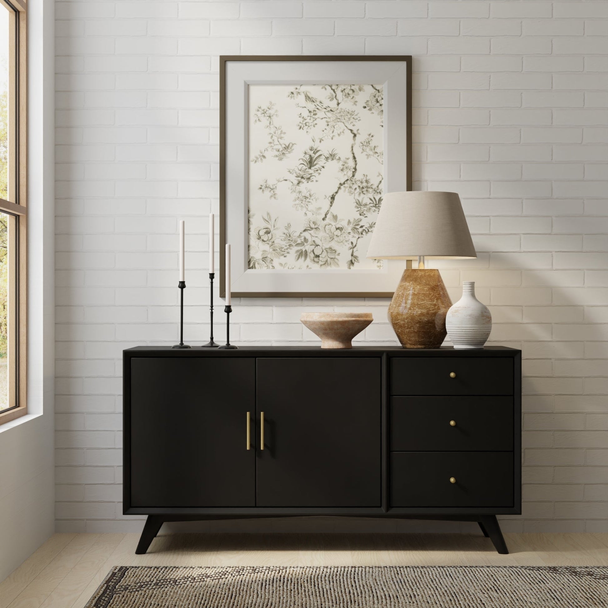 Flynn Sideboard in Black displayed in a modern living space with decor accents and natural light.