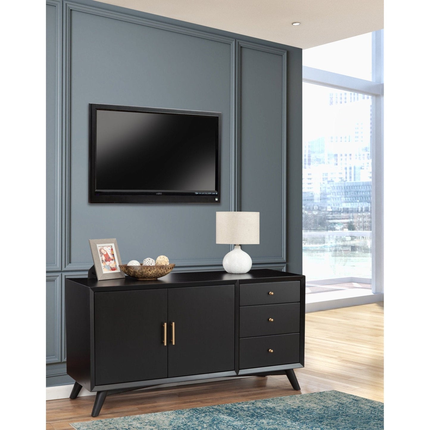 Flynn Sideboard in Black with lamp and decor against a stylish wall, showcasing contemporary elegance.
