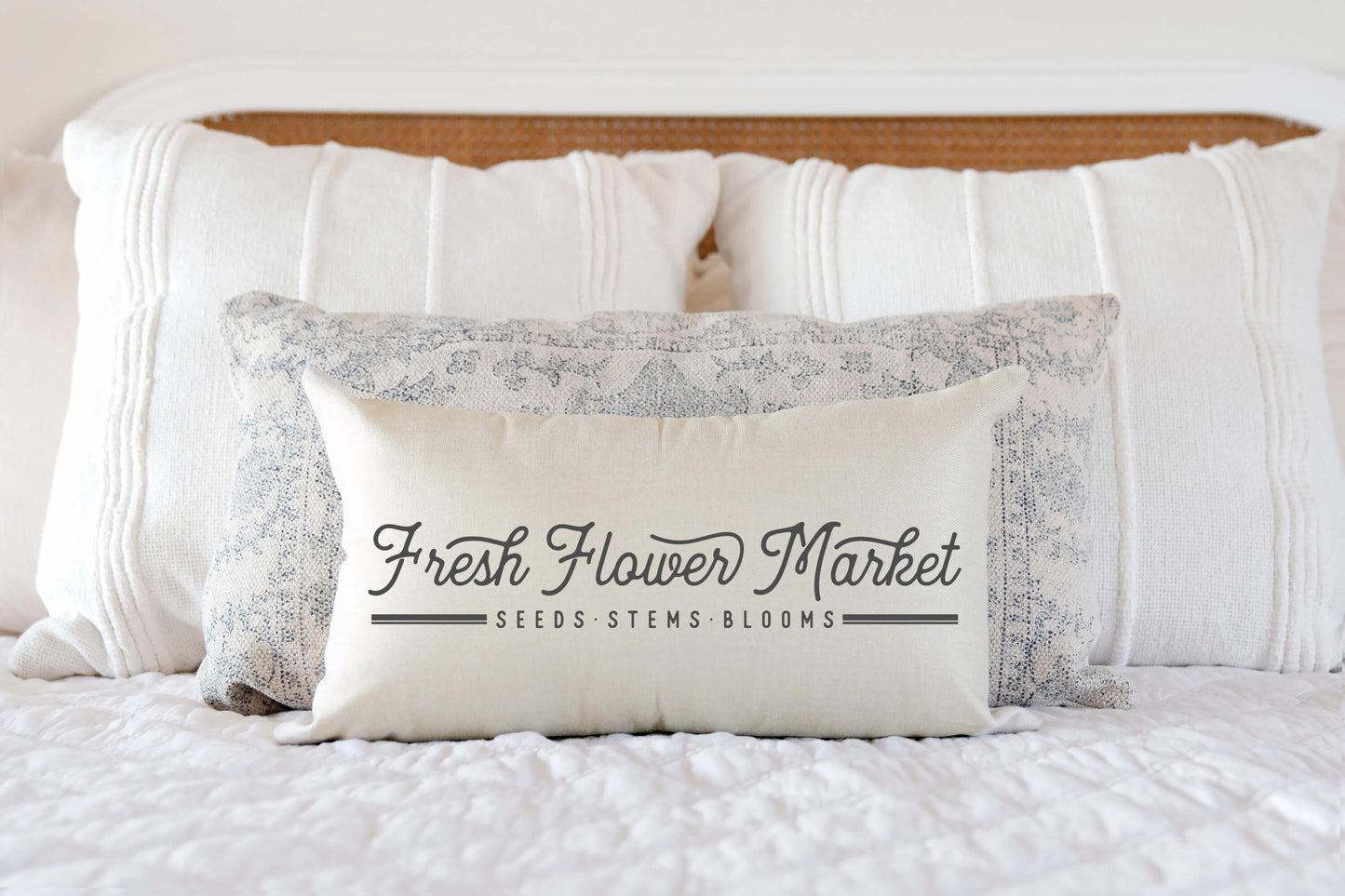 Fresh Flower Market Script Pillow Cover on a stylish bed with decorative pillows.