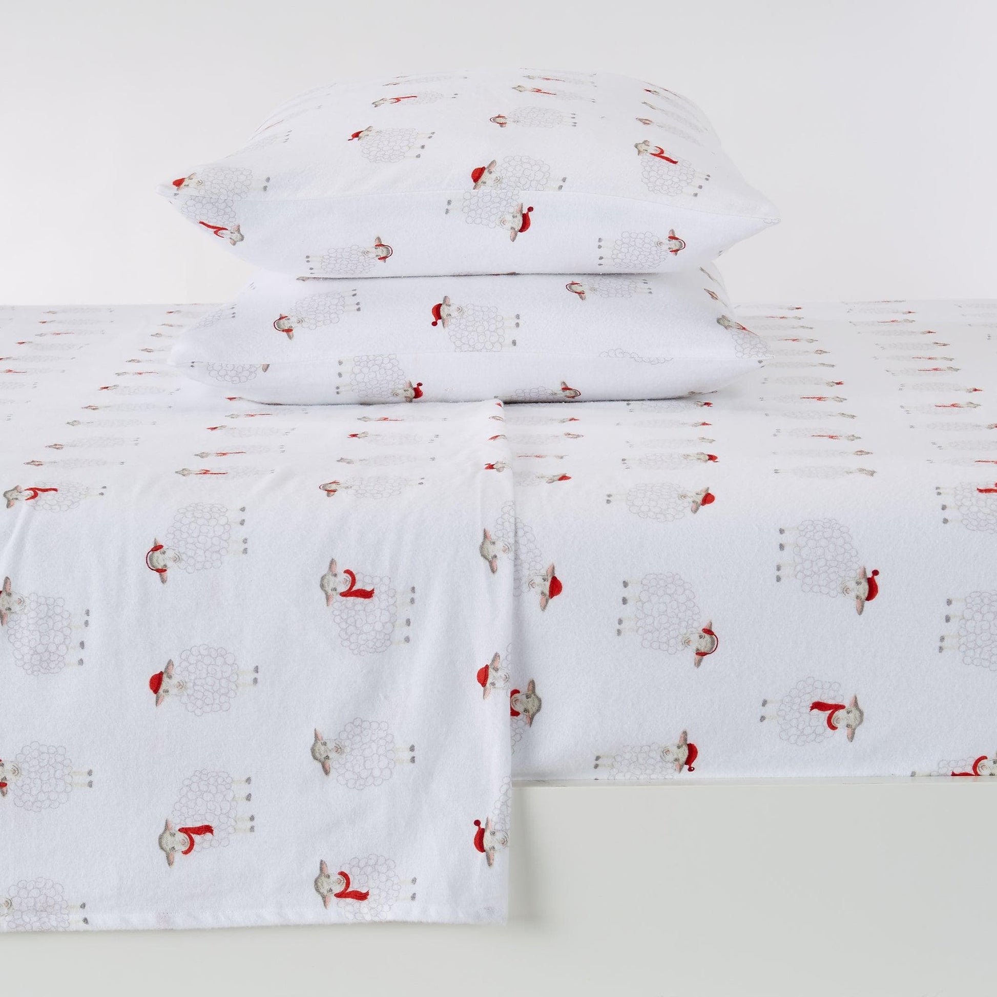 White sheet set with red and gray pattern on a white background