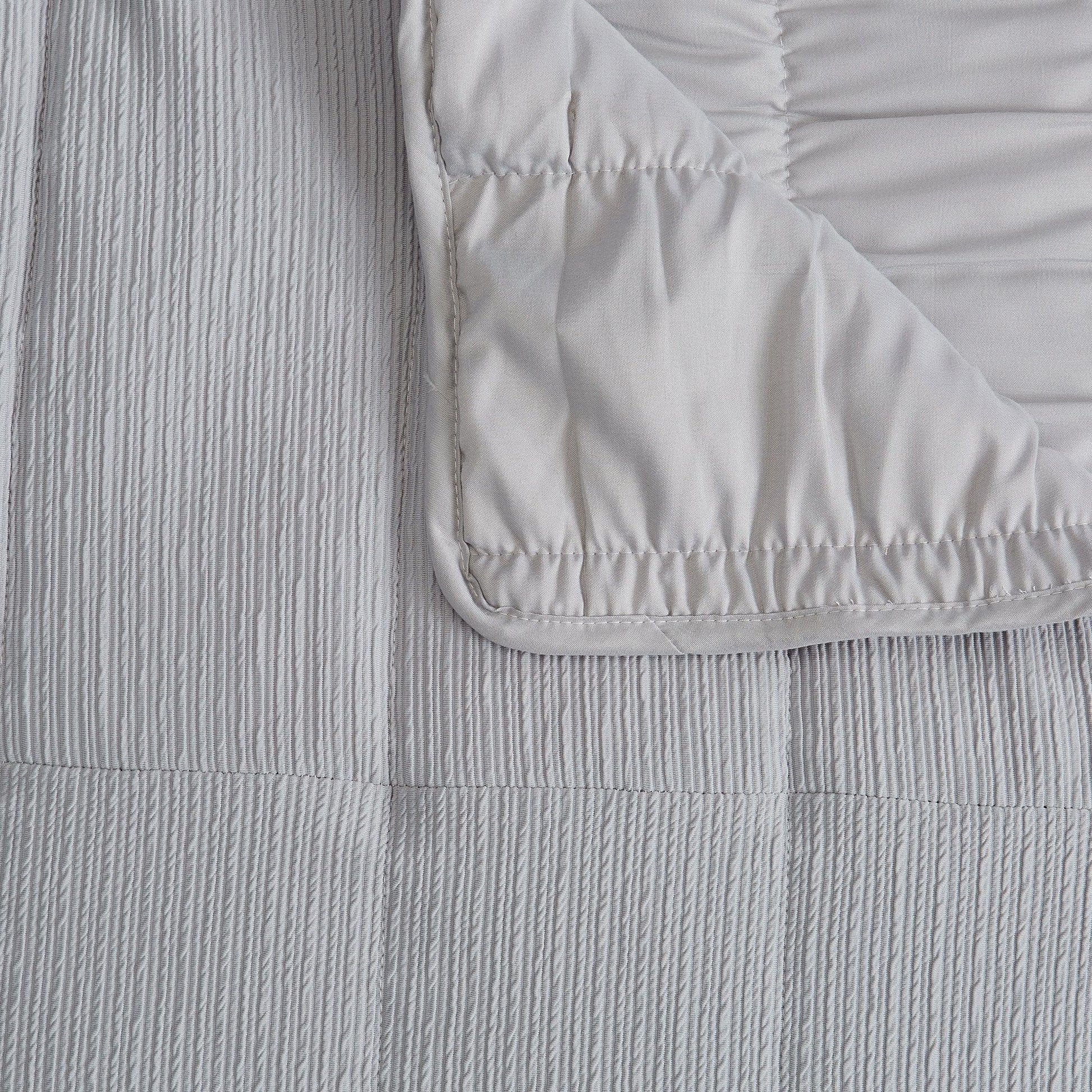 Close-up of textured gray fabric with a folded corner