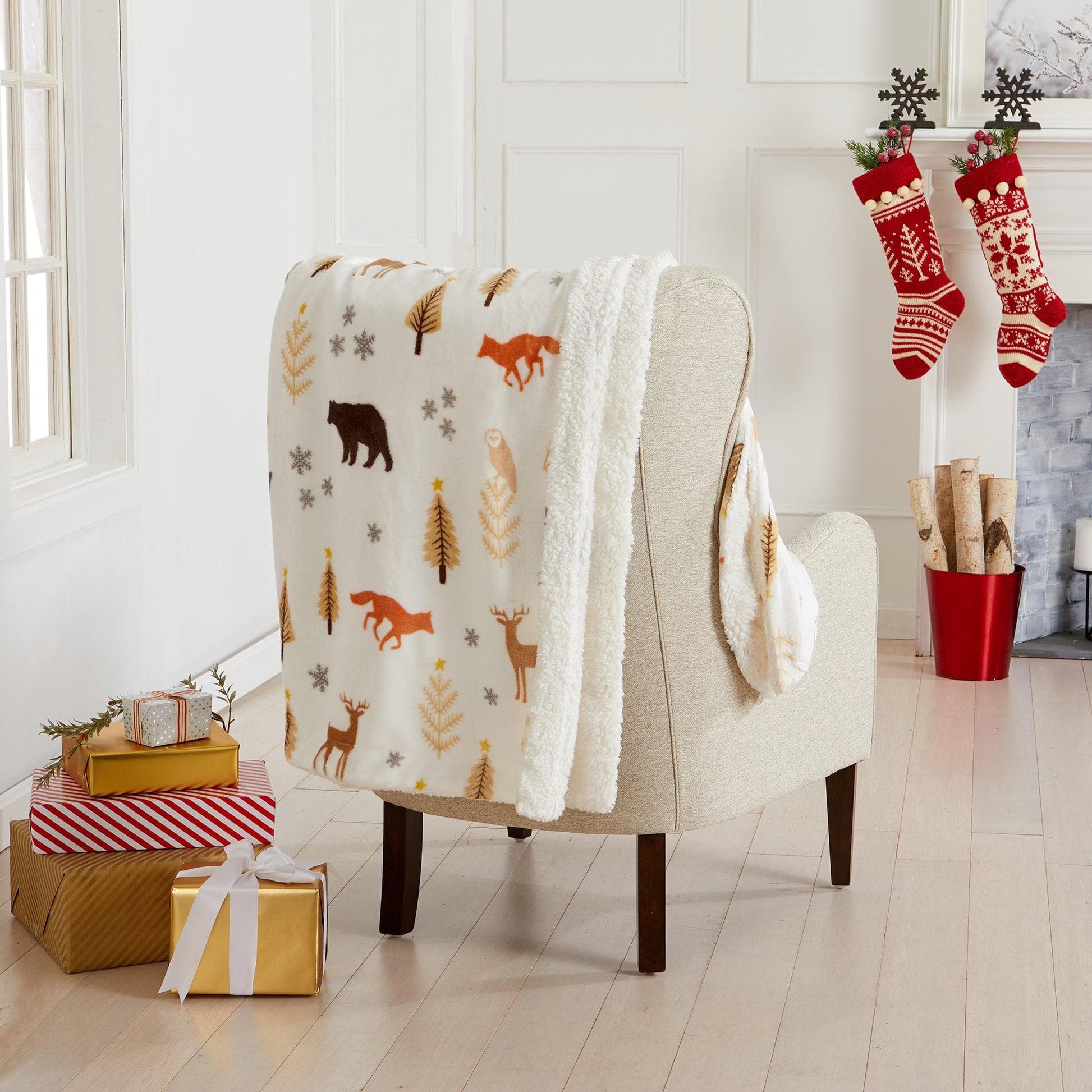 Chair with a patterned blanket draped over it, surrounded by Christmas decorations including stockings and presents.