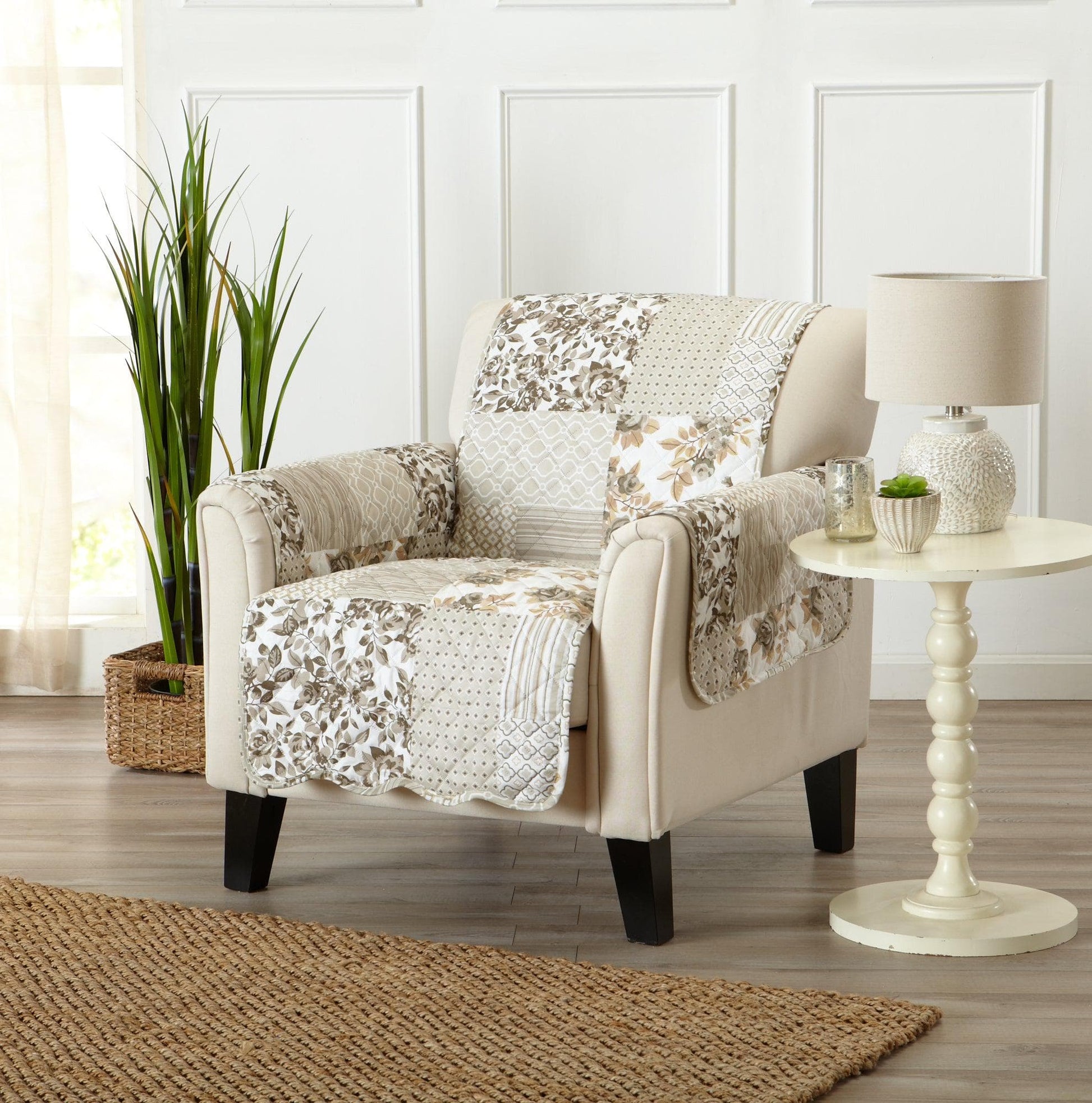 Beige armchair with a floral-patterned throw blanket in a living room setting.