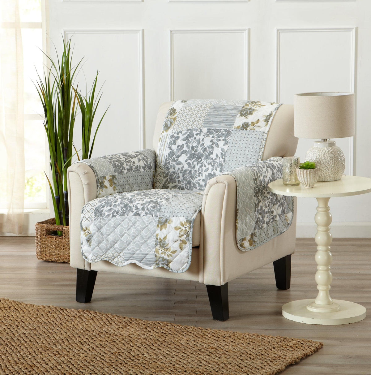 Beige armchair with a patchwork quilt draped over it in a living room setting.