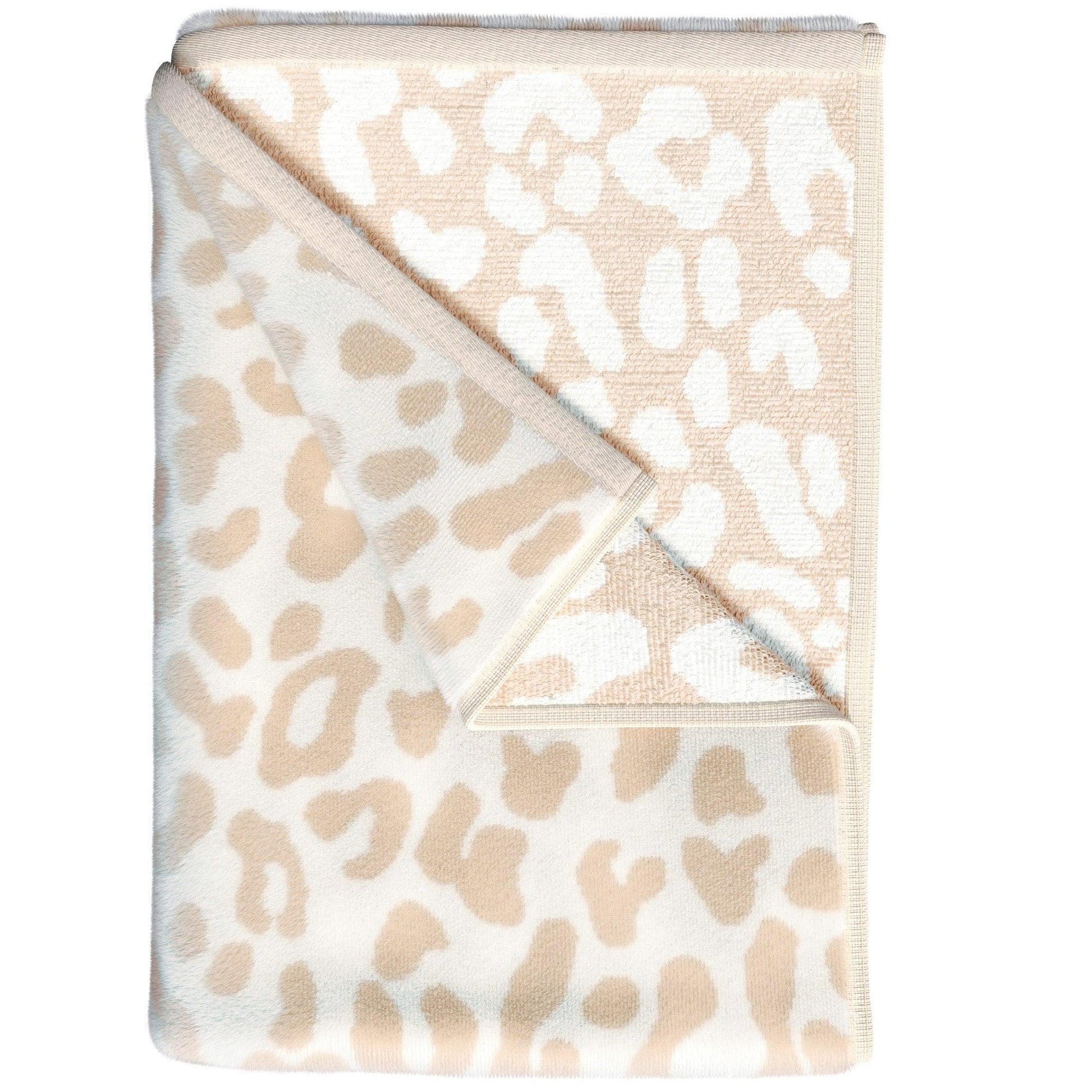 Folded beige and white leopard print blanket on a white background