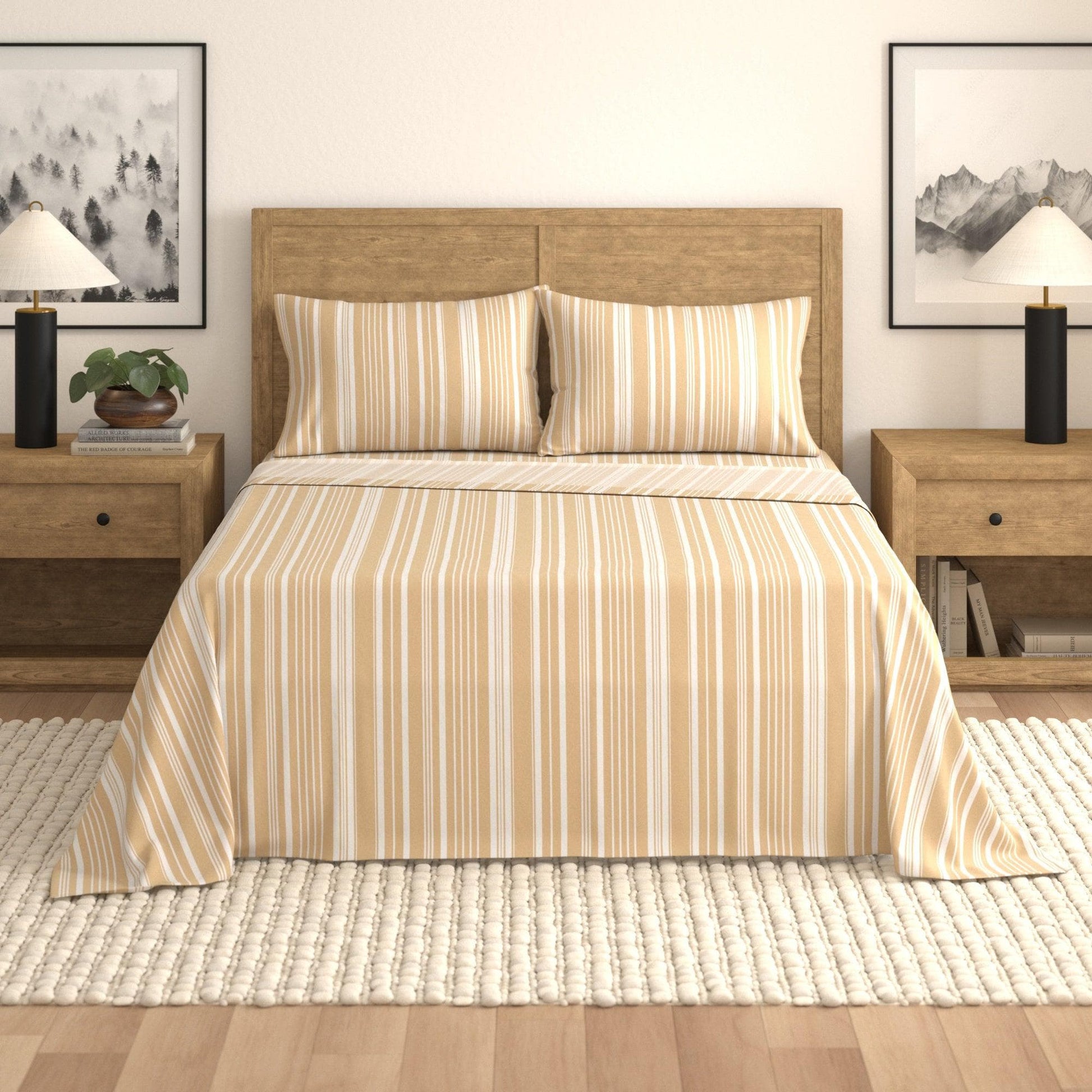 Bed with striped bedding in a bedroom setting with nightstands and lamps.