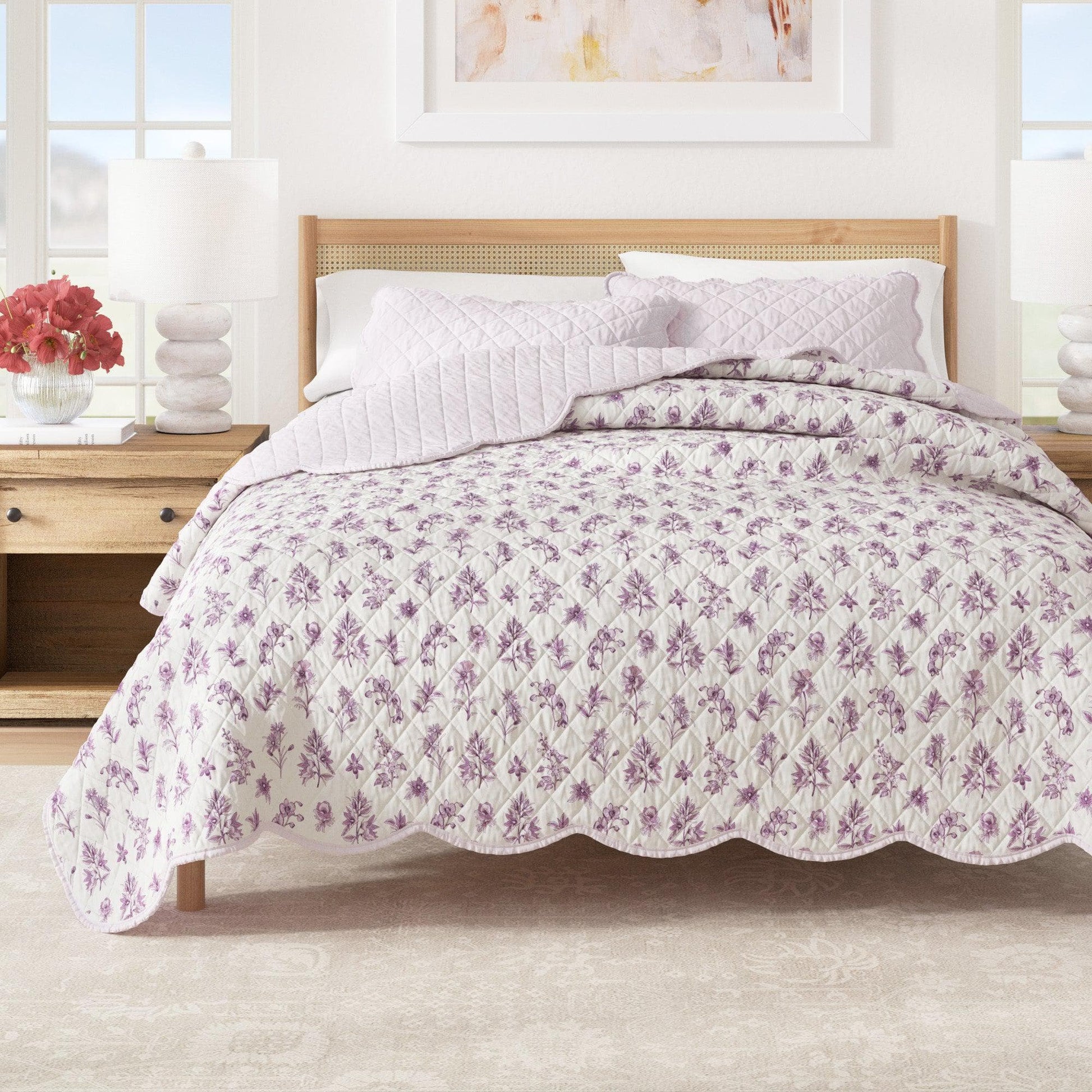 Floral quilt on a bed in a bright bedroom setting