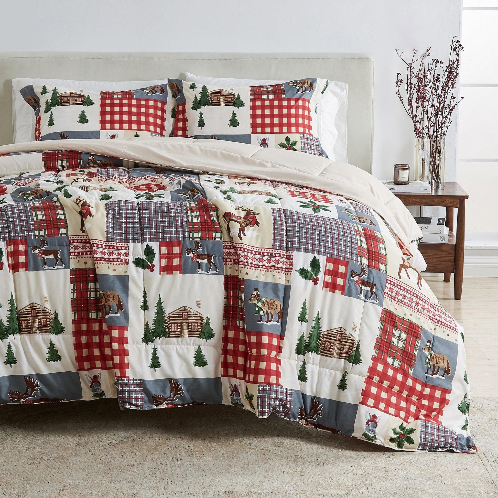Patchwork quilt with nature-themed design on a bed in a bedroom setting.