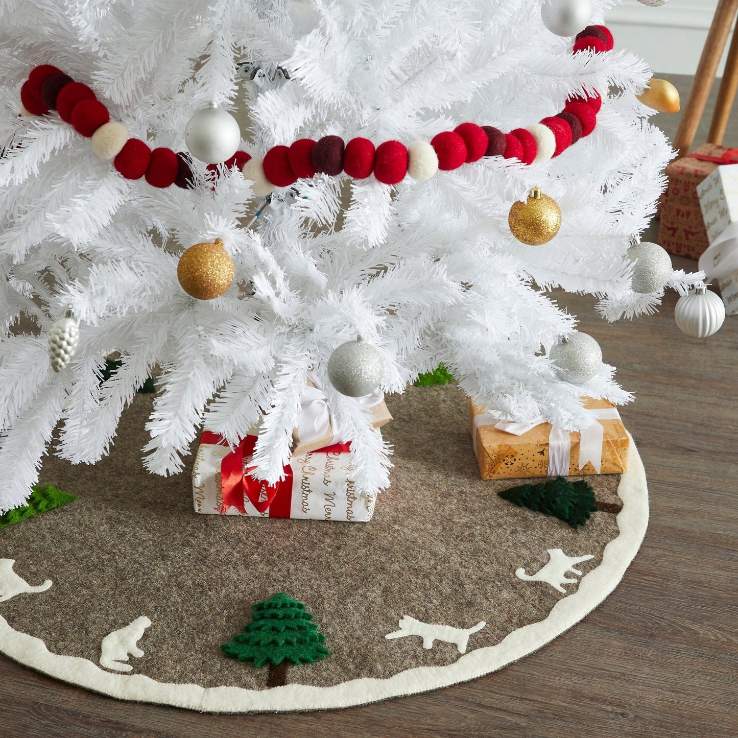 Handmade Felted Cats and Green Trees Grey Christmas Tree Skirt under white Christmas tree with presents.