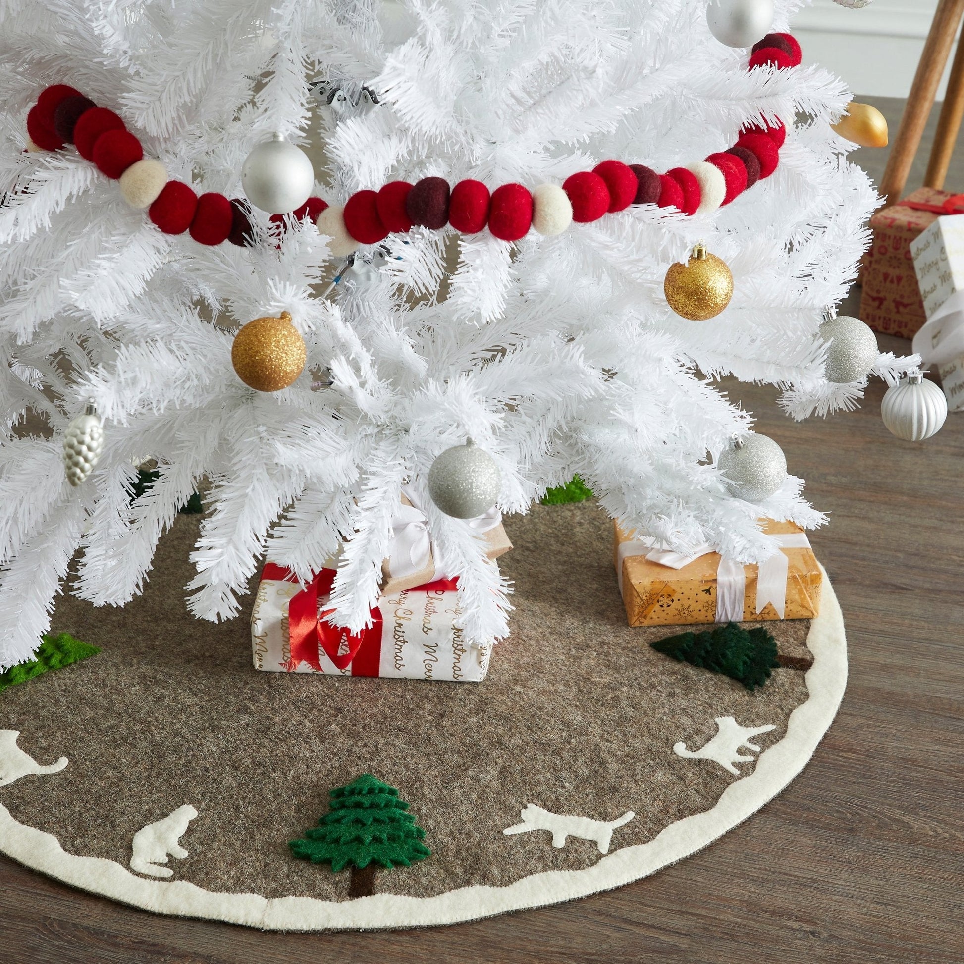 Handmade Felted Cats and Green Trees Grey Christmas Tree Skirt under white Christmas tree with presents.