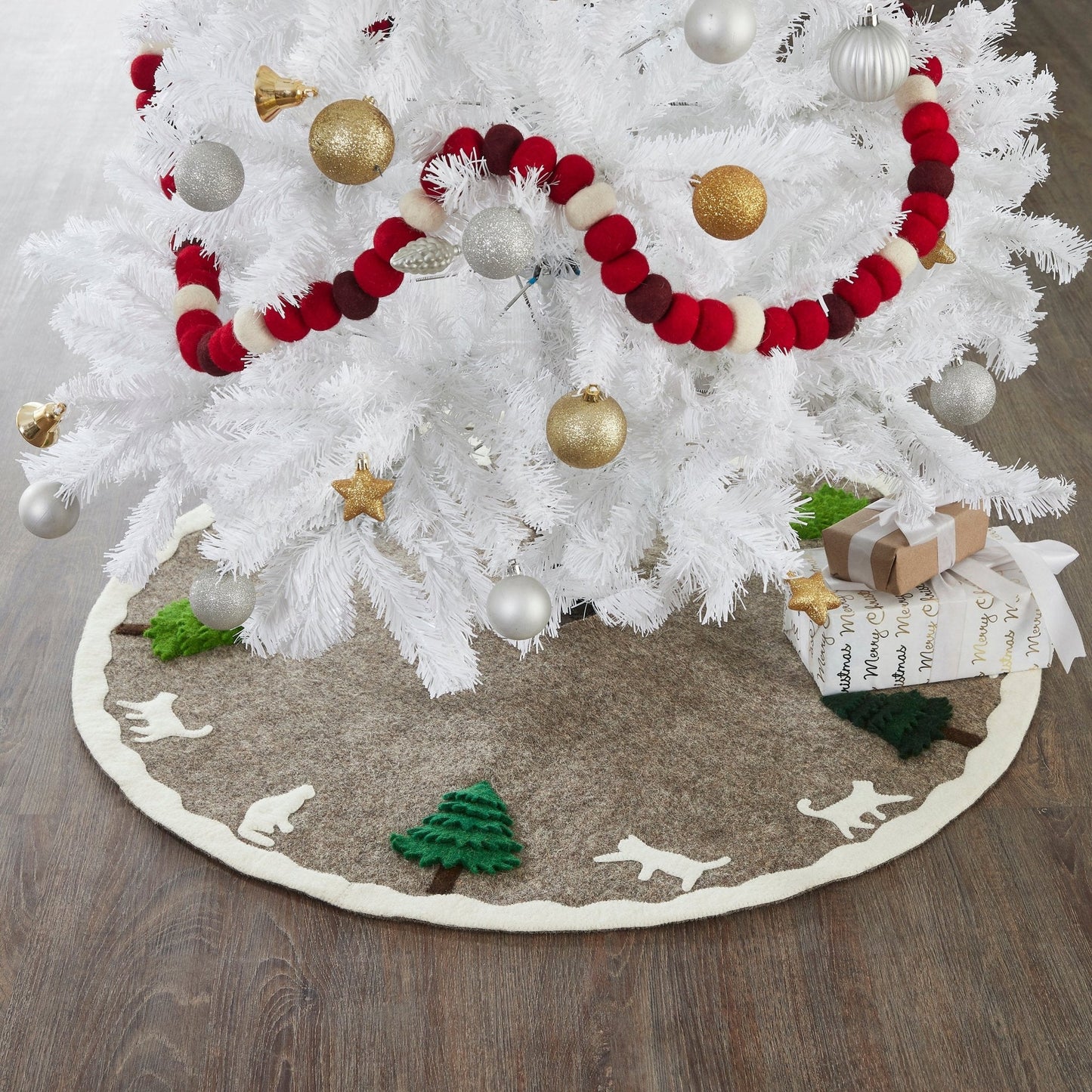 Handmade Felted Cats and Green Trees Grey Christmas Tree Skirt under a white tree with ornaments and gifts.