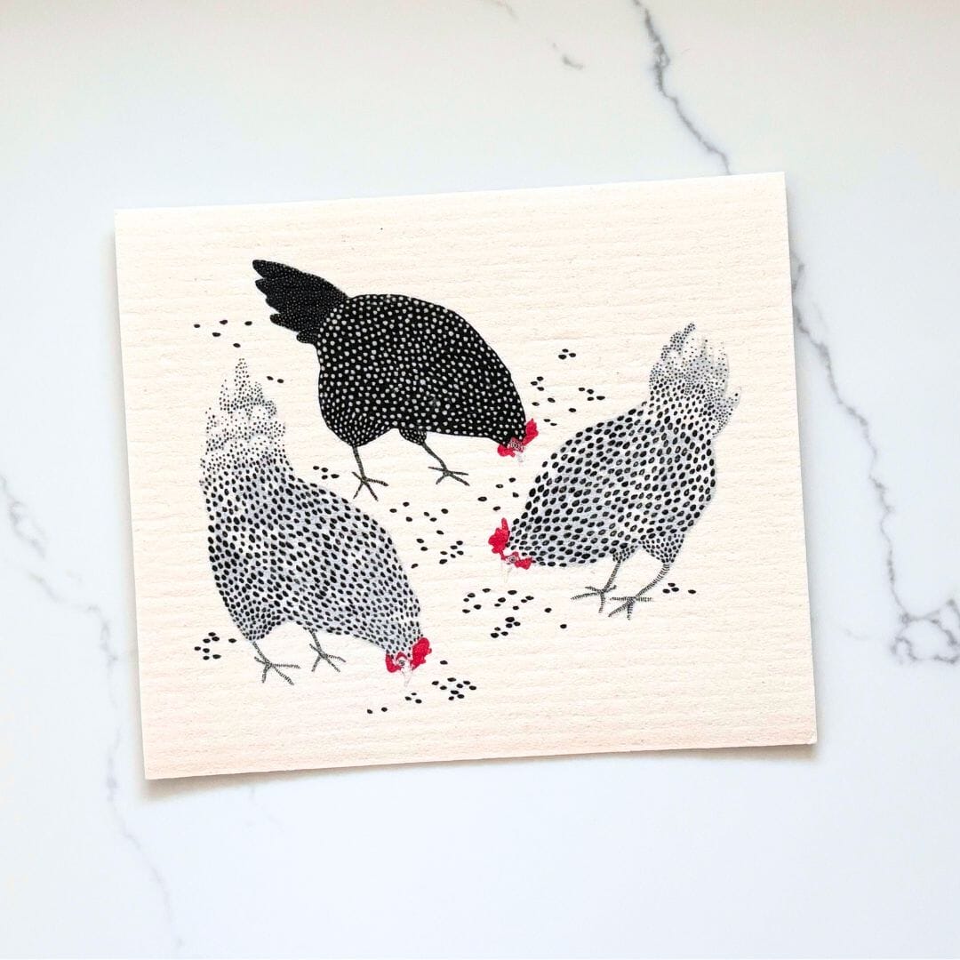 Dishcloth with chicken illustrations on a marble surface