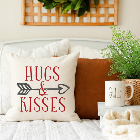 Hugs and Kisses Valentine's Day Pillow Cover on a couch with decorative elements.