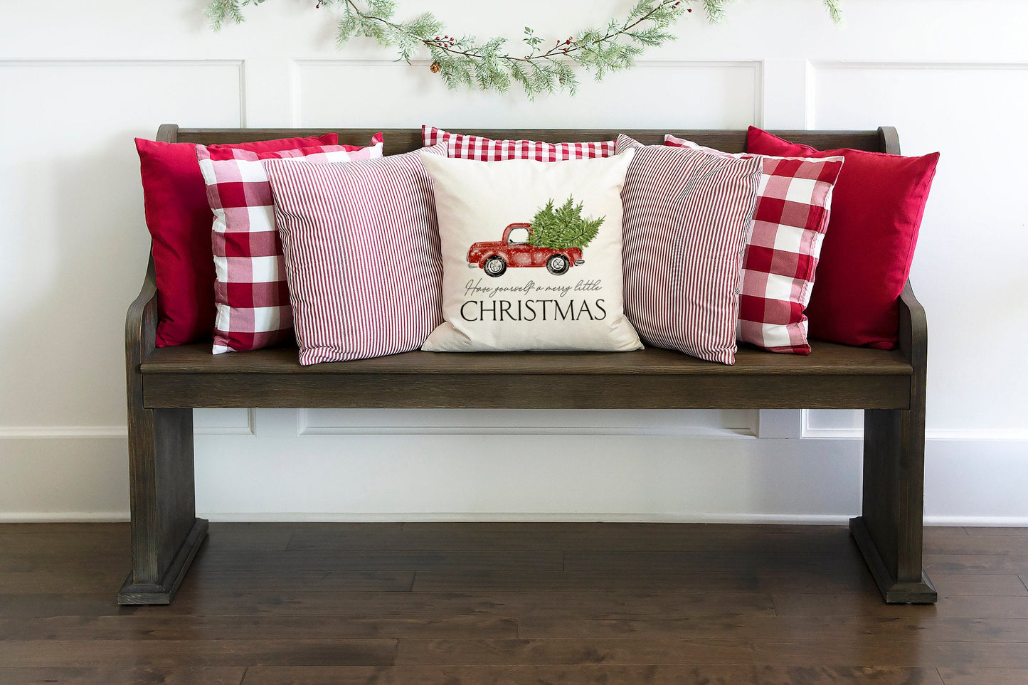 Christmas Truck and Tree 18x18 inch Pillow Cover displayed on a cozy bench with festive pillows.