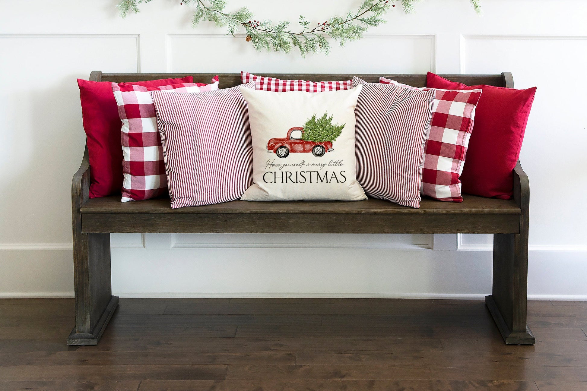 Christmas Truck and Tree 18x18 inch Pillow Cover displayed on a cozy bench with festive pillows.