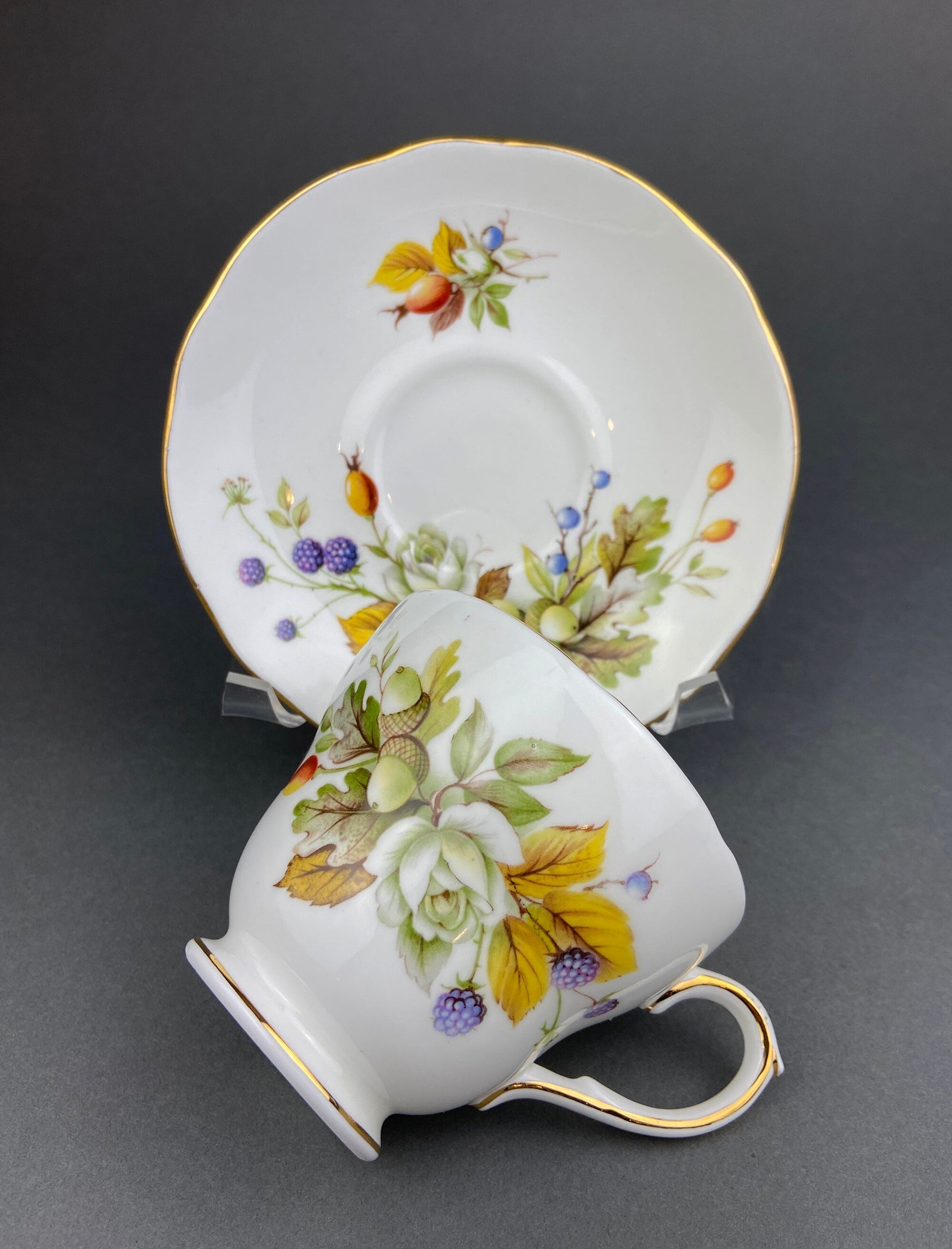 Teacup and saucer with floral design on a gray background