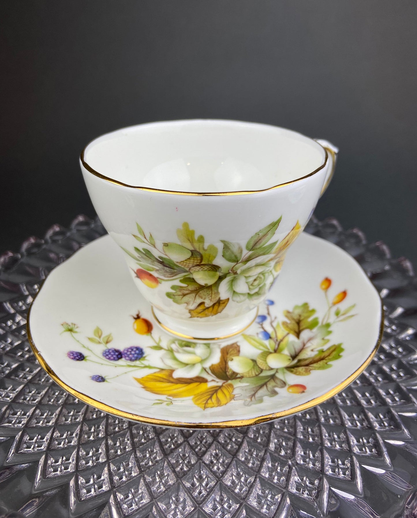 Teacup with floral design on a saucer on a textured surface