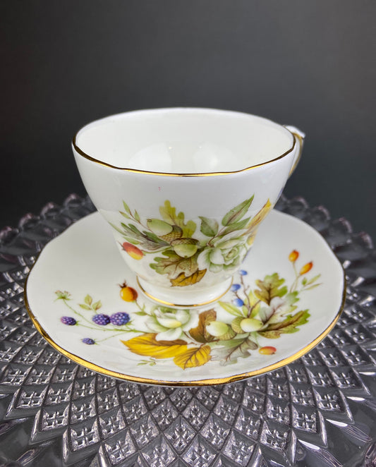 Teacup with floral design on a saucer on a textured surface