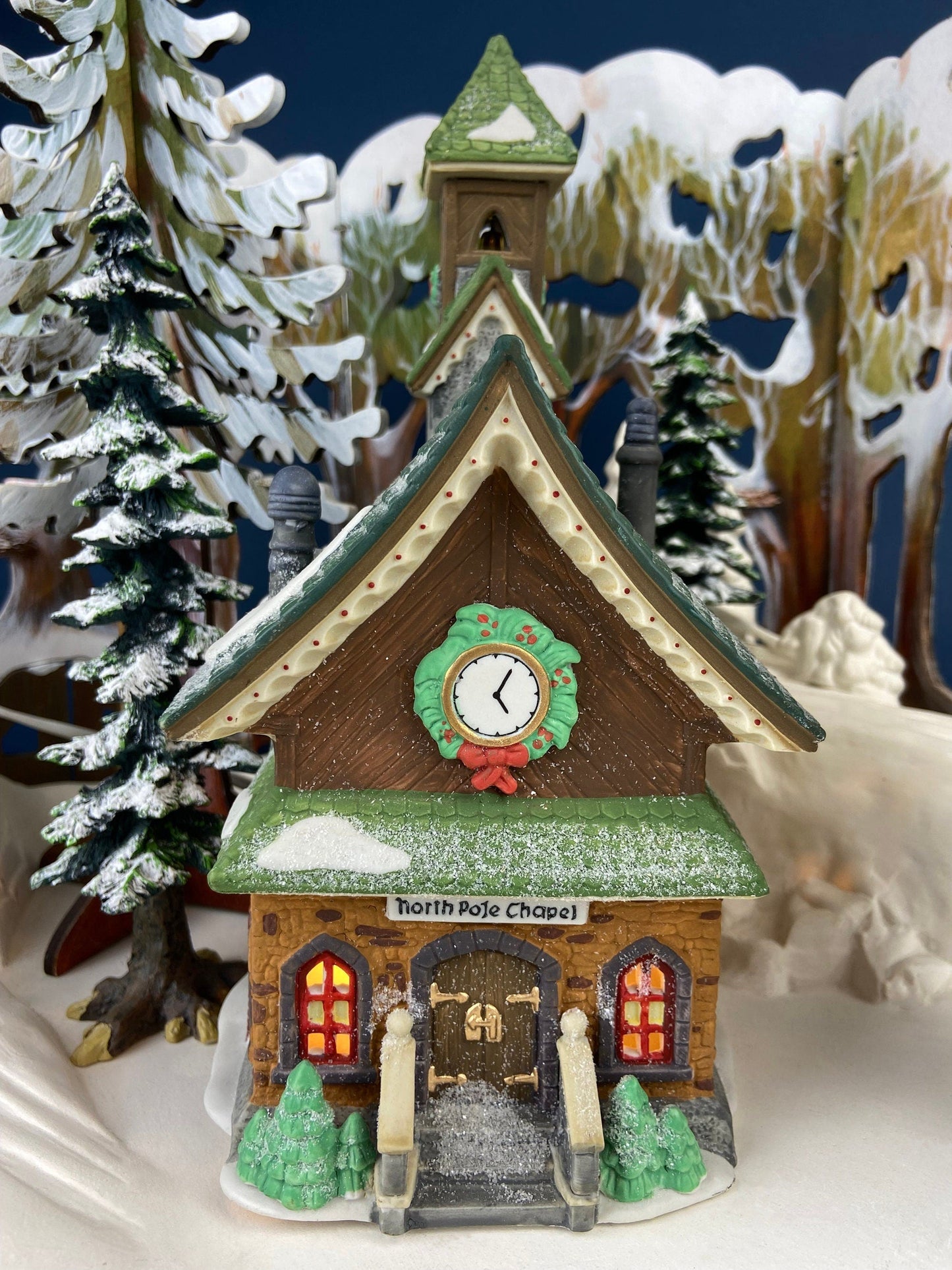 Christmas Village Church with Stained Glass Window. Illuminated House of Worship. Holiday Decor. Christmas Celebration.