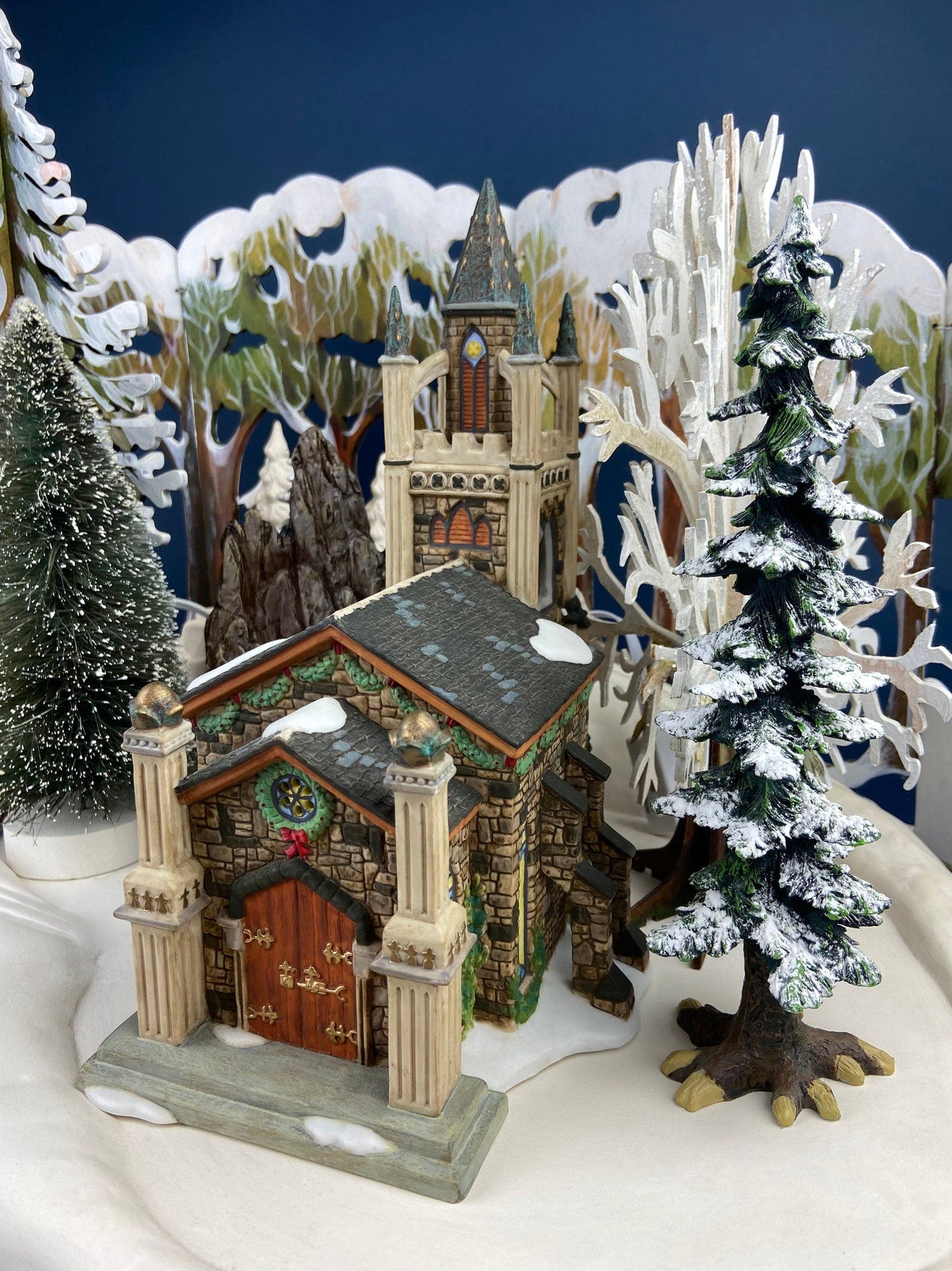 Christmas Village Church with Stained Glass Window. Illuminated House of Worship. Holiday Decor. Christmas Celebration.