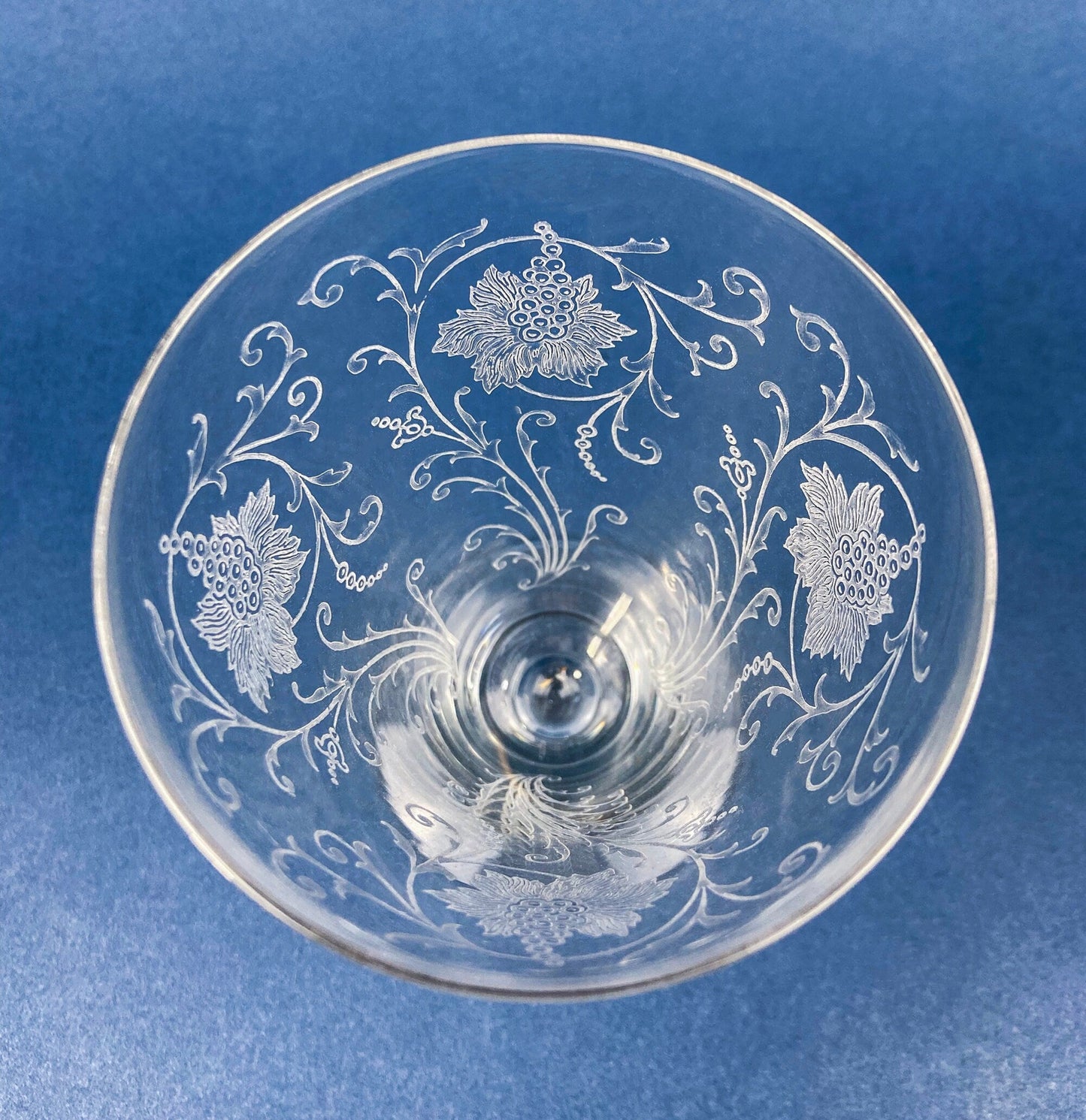 Decorative glass bowl with floral patterns on a blue background