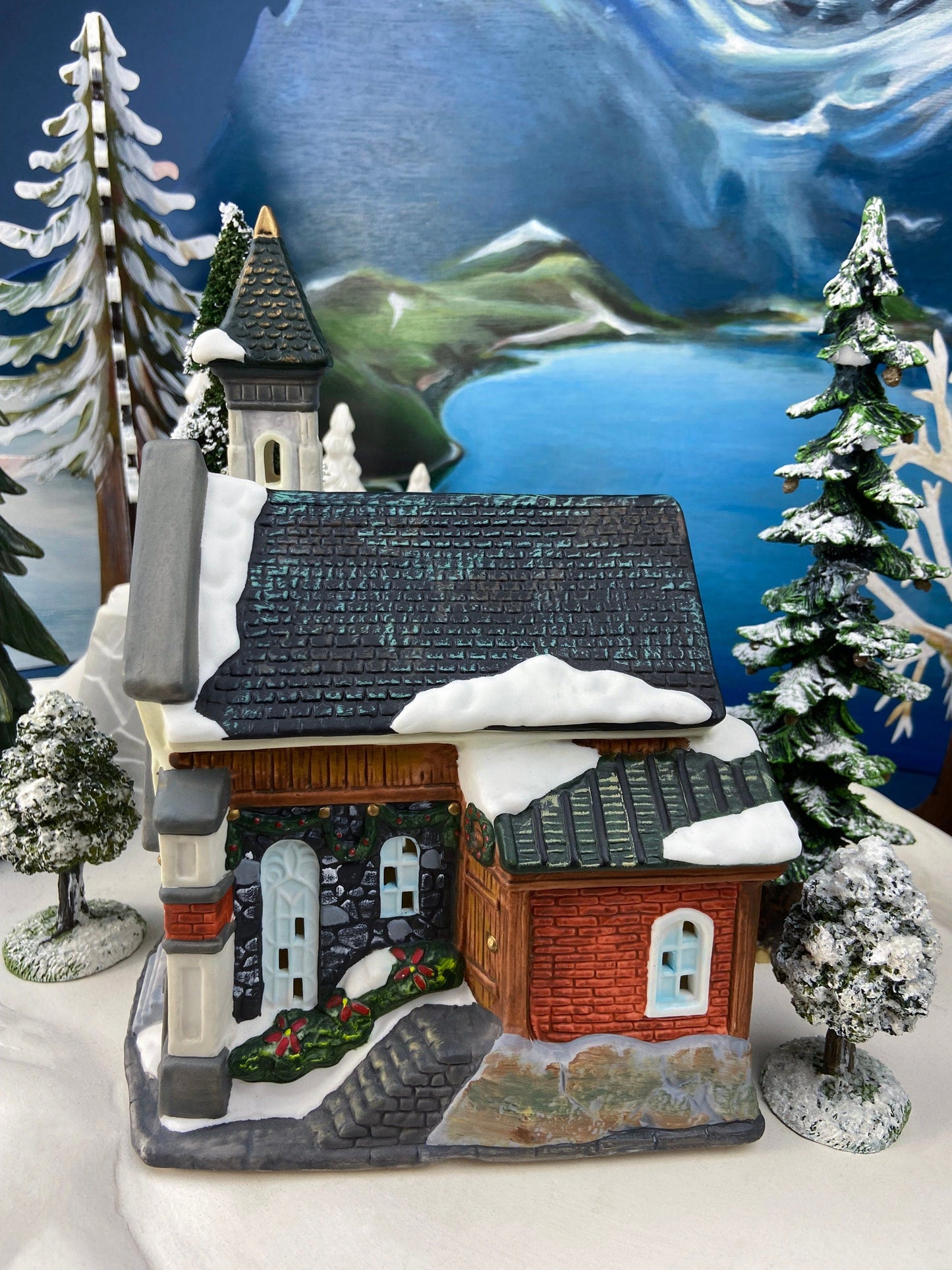 Christmas Village Church with Stained Glass Window. Illuminated House of Worship. Holiday Decor. Christmas Celebration.