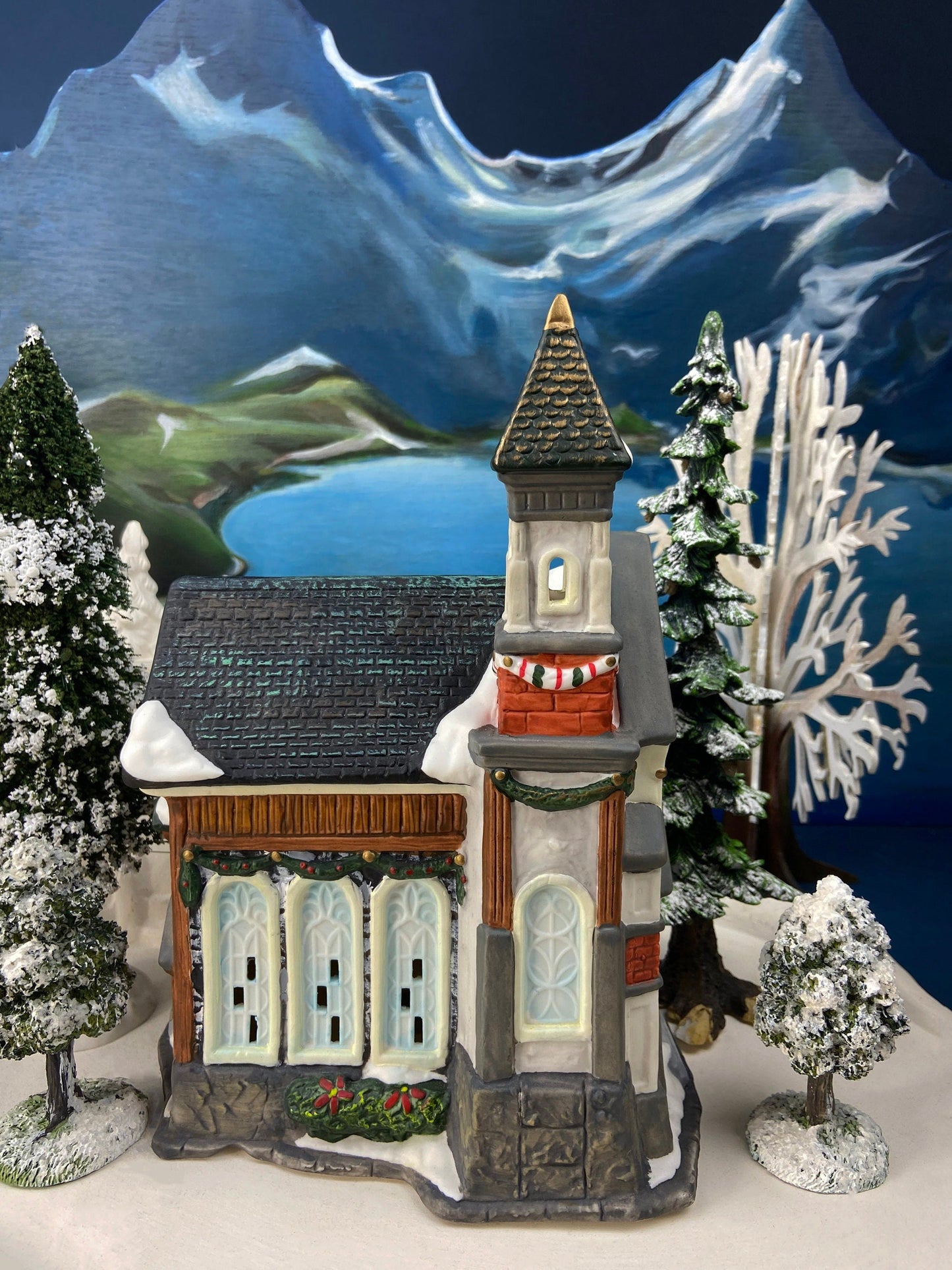 Christmas Village Church with Stained Glass Window. Illuminated House of Worship. Holiday Decor. Christmas Celebration.