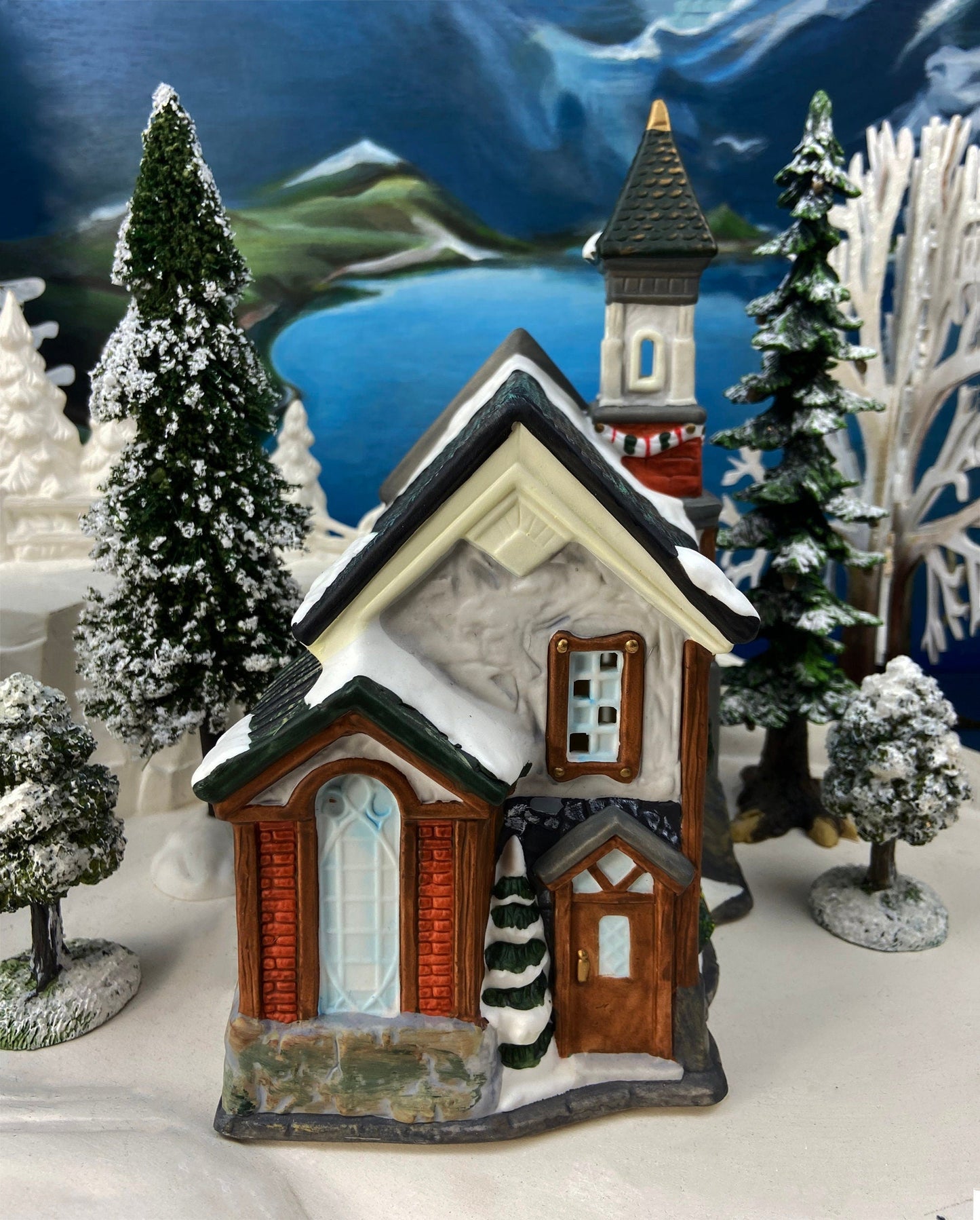 Christmas Village Church with Stained Glass Window. Illuminated House of Worship. Holiday Decor. Christmas Celebration.