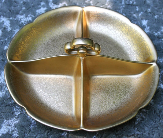 Gold decorative item on a textured gray surface