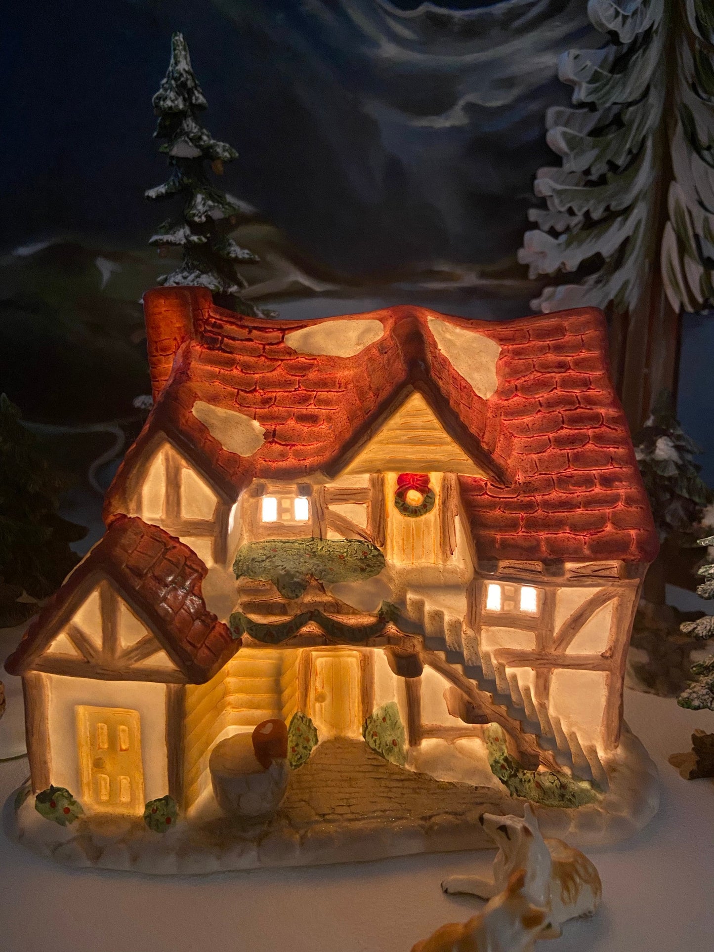 Christmas Village Farm House with Red Roof. Illuminated Building Holiday Decoration.