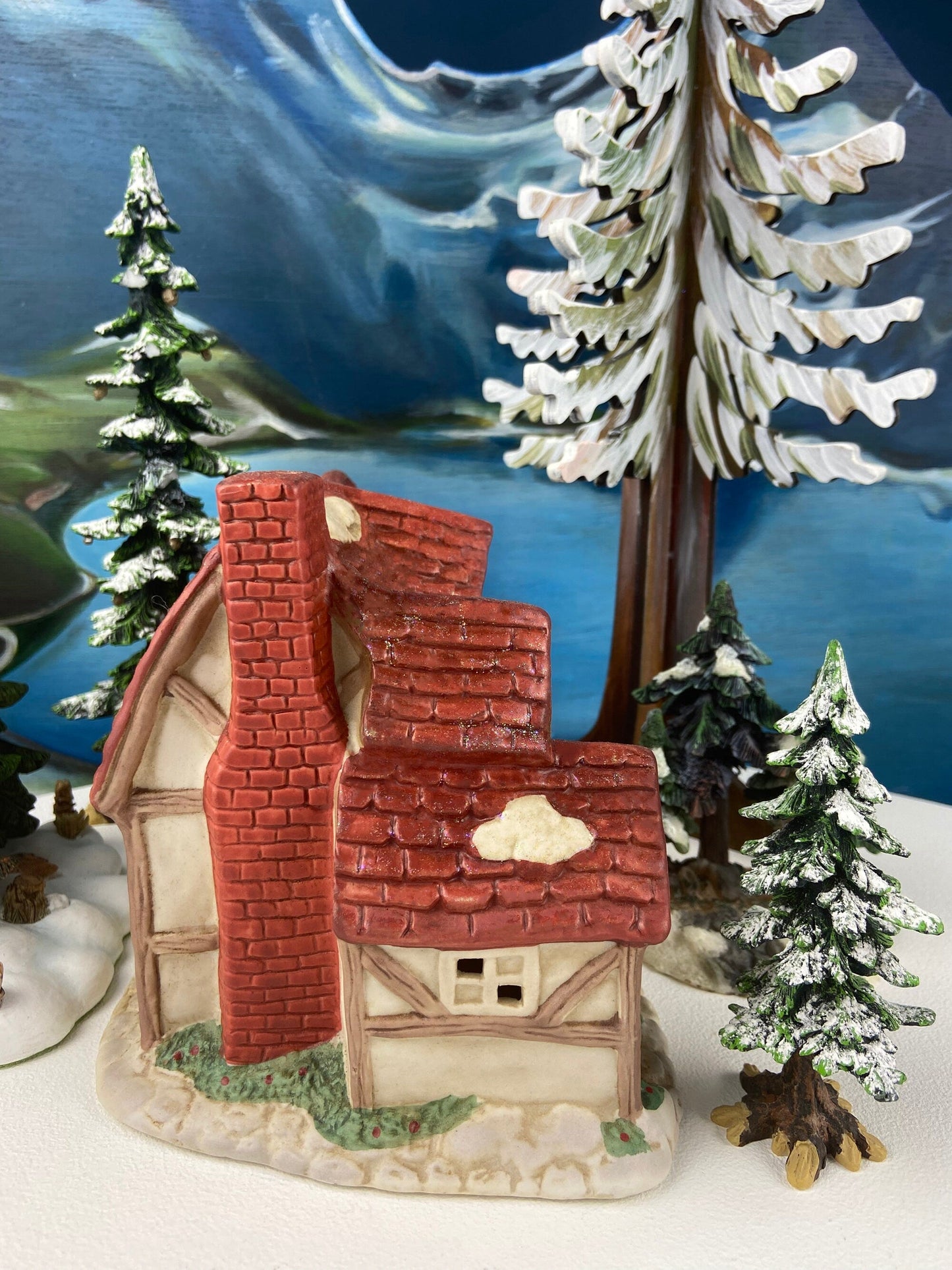 Christmas Village Farm House with Red Roof. Illuminated Building Holiday Decoration.