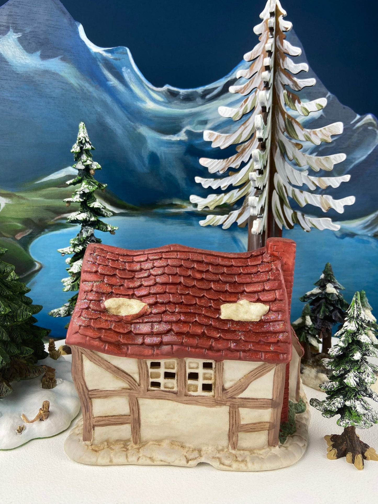 Christmas Village Farm House with Red Roof. Illuminated Building Holiday Decoration.