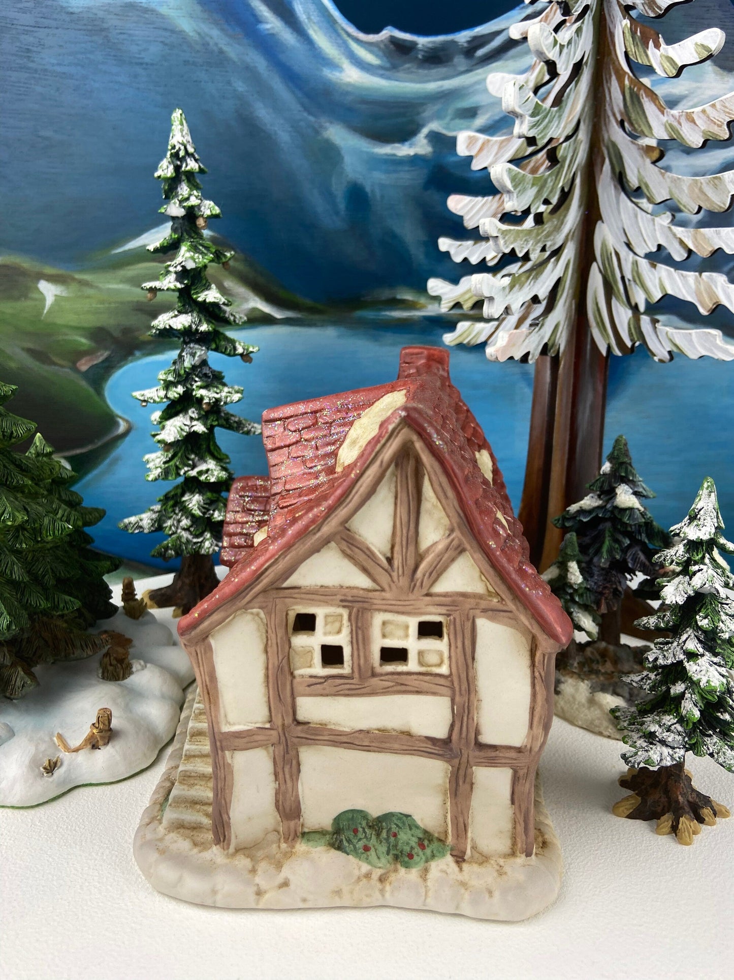 Christmas Village Farm House with Red Roof. Illuminated Building Holiday Decoration.