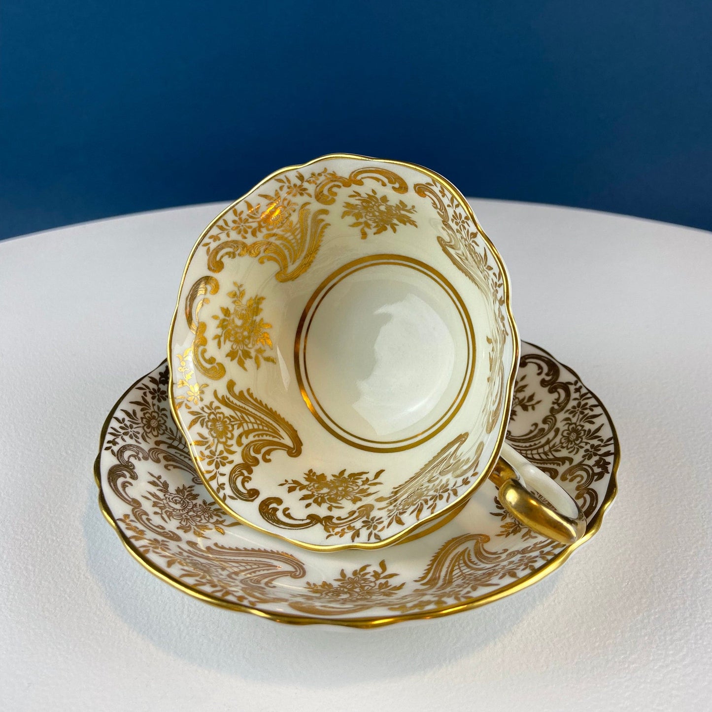 White and Gold Cup and Saucer. Paragon Porcelain, By Appointment to Her Majesty the Queen Potters. Dining Room Cabinet Display.