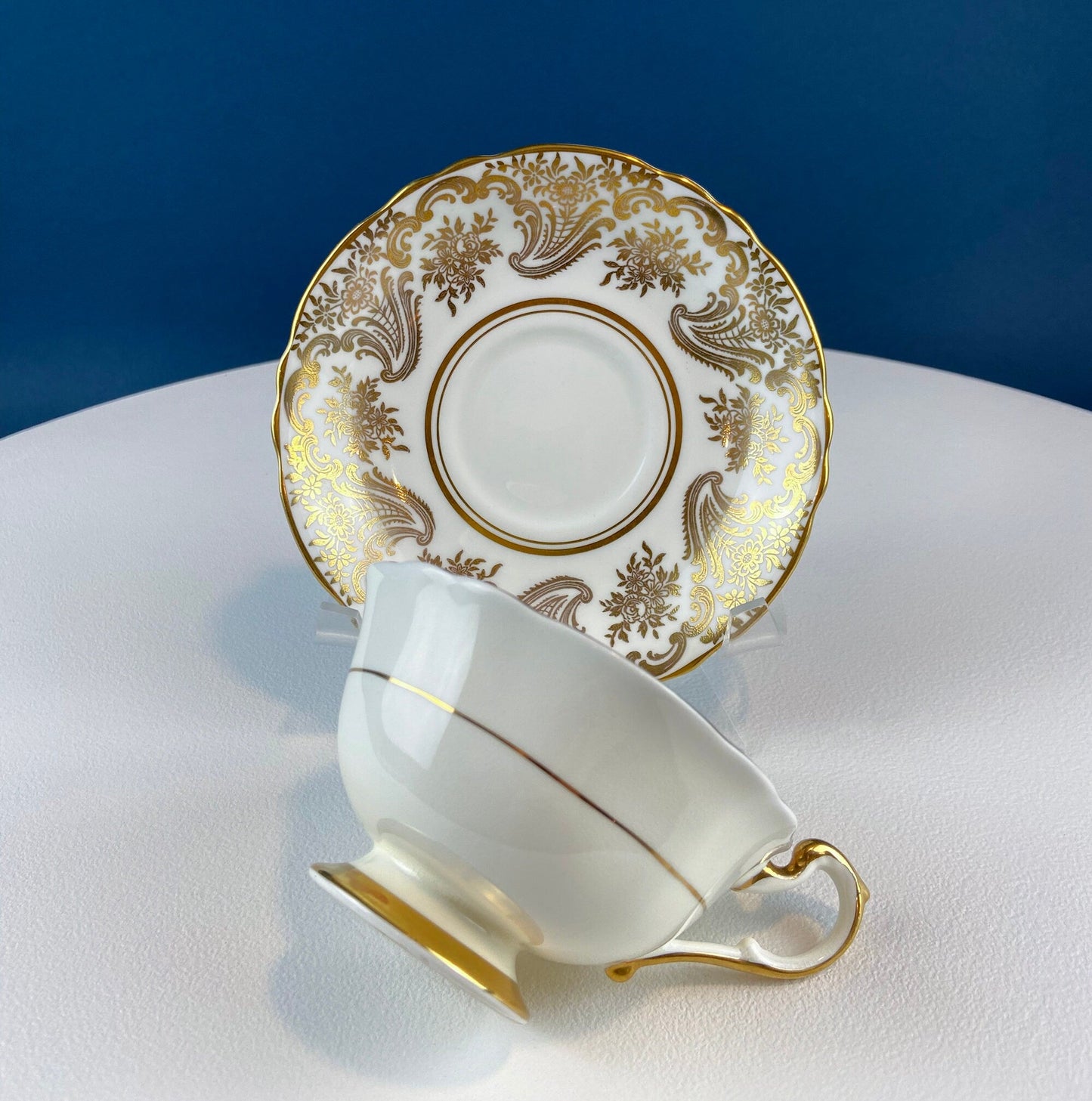 White and Gold Cup and Saucer. Paragon Porcelain, By Appointment to Her Majesty the Queen Potters. Dining Room Cabinet Display.