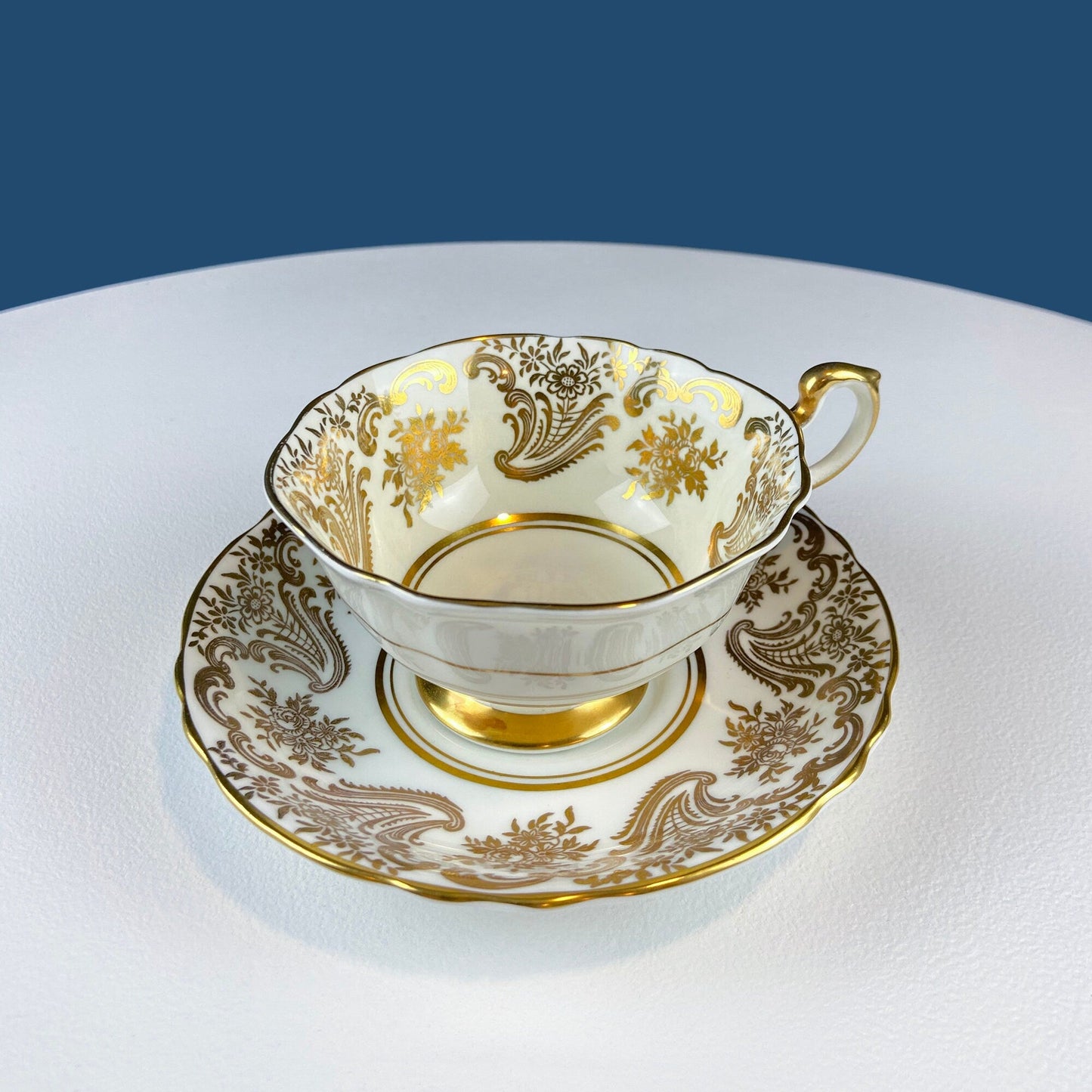 White and Gold Cup and Saucer. Paragon Porcelain, By Appointment to Her Majesty the Queen Potters. Dining Room Cabinet Display.