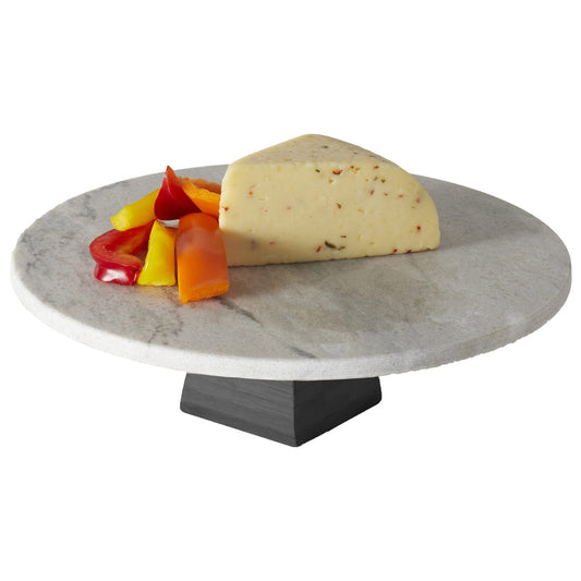 Marble cheese board with a wedge of cheese and fruit on a white background