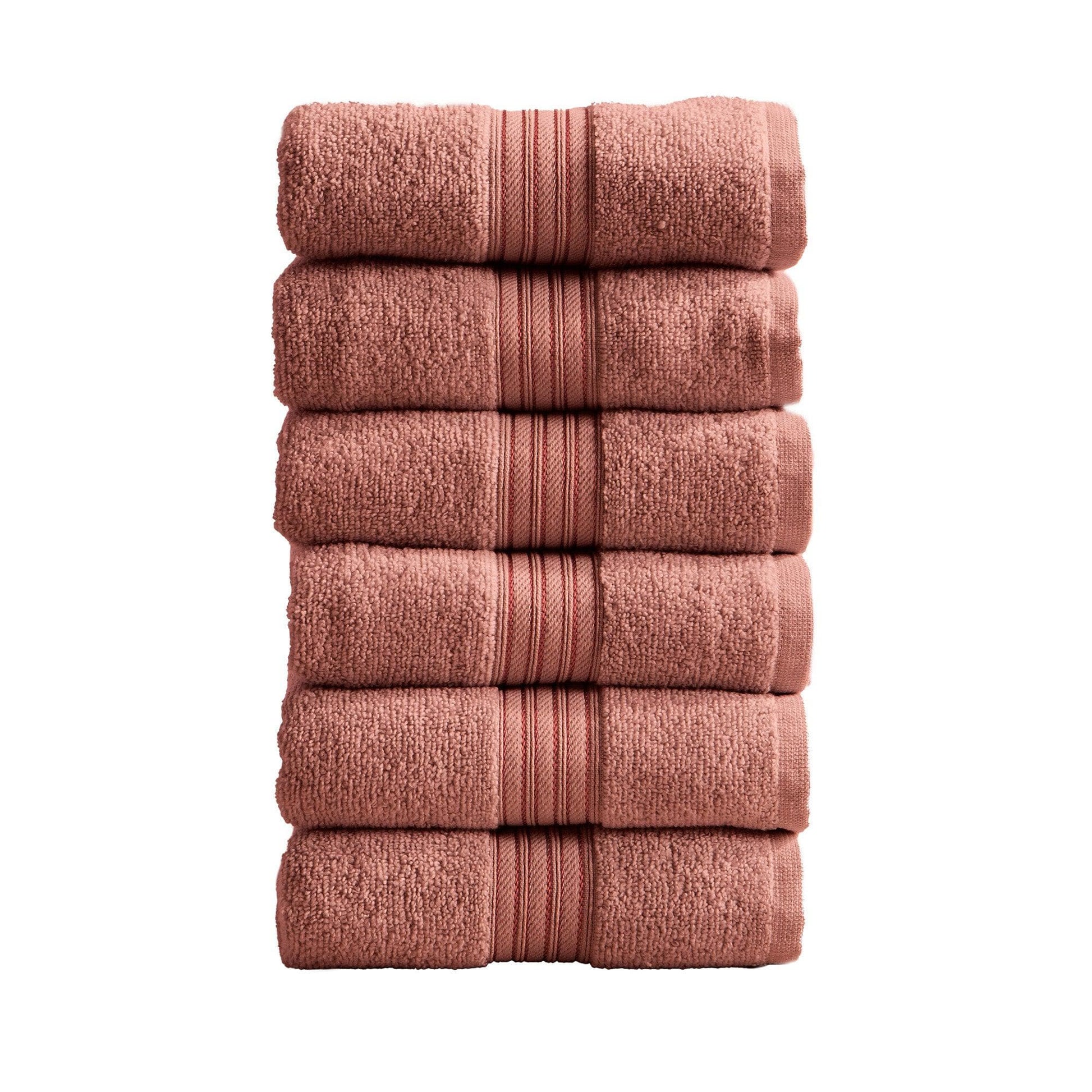 Stack of five folded pink towels on a white background