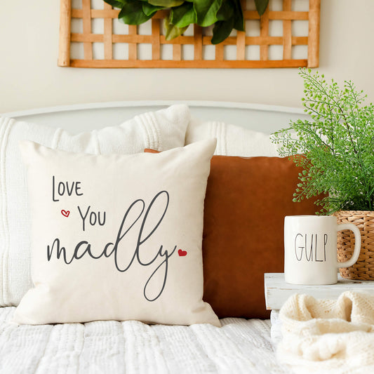 Love You Madly Valentine's Day Pillow Cover 18x18 styled on a cozy couch with decorative elements.