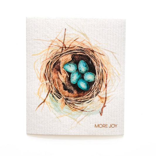 Dishcloth with a painting of a nest with blue eggs and 'More Joy' text on a white background